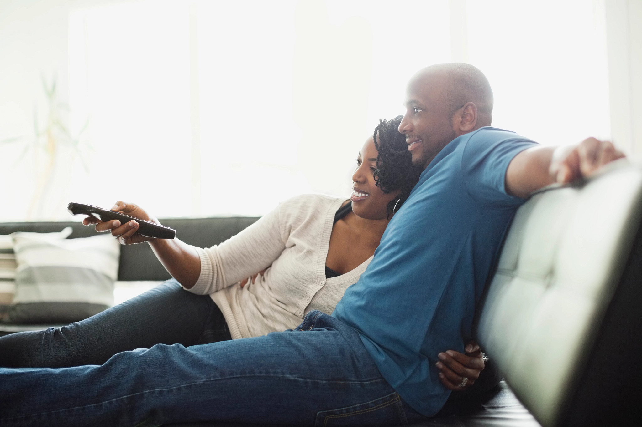 couple sitting on couch watching tv