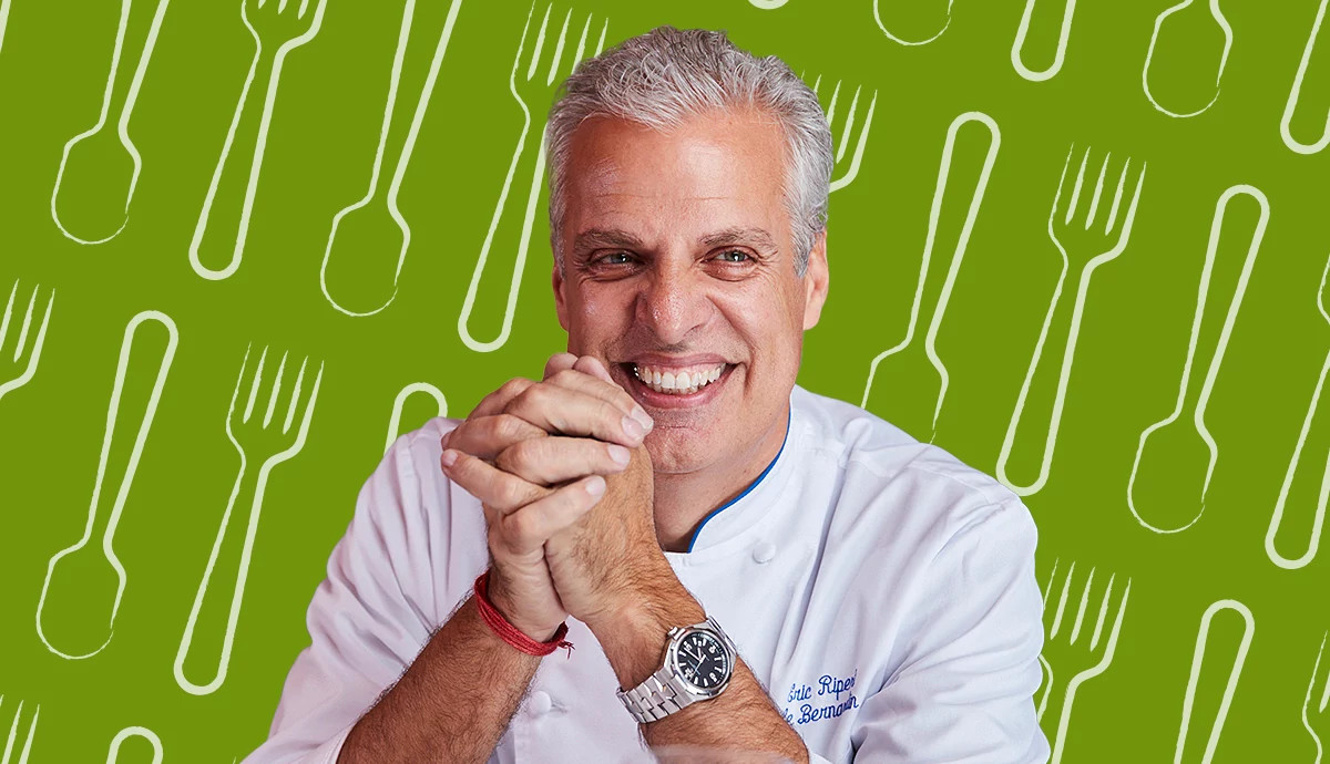 Chef Eric Ripert in front of a food-themed background