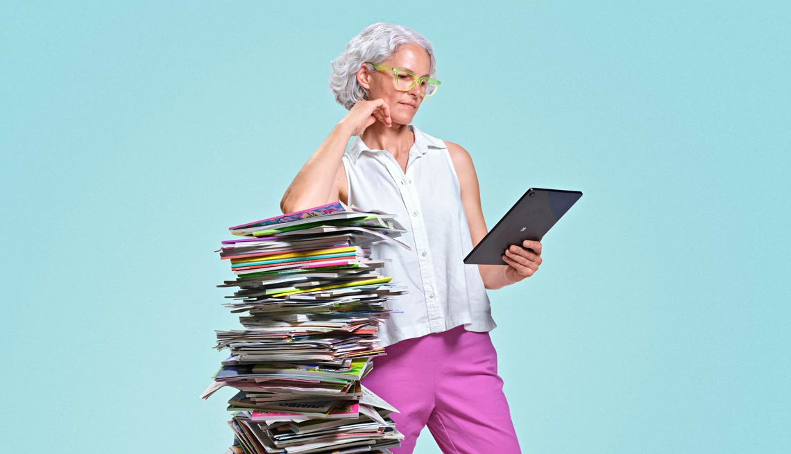 News aggregators can unlock some paywalls A woman landing on a pile of notebooks looking at a tablet
