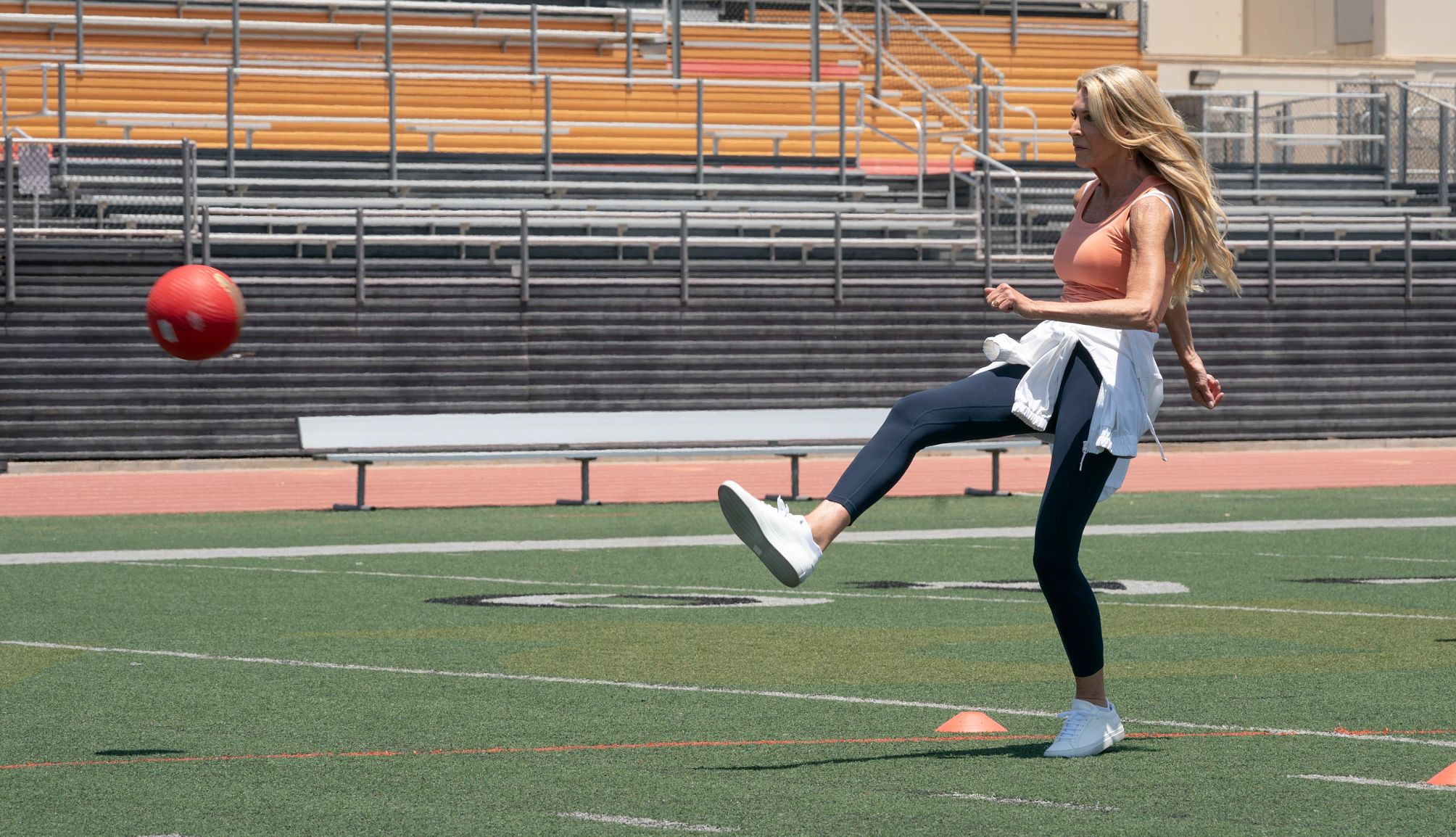 The Golden Bachelorette Joan Vassos The Golden Bachelorette Joan Vassos kicking a ball on an athletic field