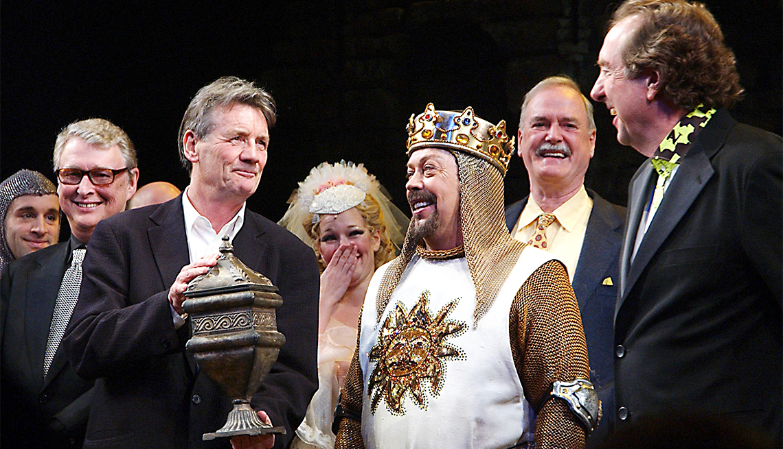 Director Mike Nichols looks on as Monty Python member Michael Palin holds a symbolic urn representing deceased Python member Graham Chapman, actor Tim Curry and Python members John Cleese and Eric Idle (shows composer/lyrcist) take part in the opening night curtain call bows on March 17, 2005 for the Monty Python Broadway musical Spamalot