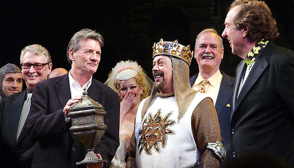 Spamalot Director Mike Nichols looks on as Monty Python member Michael Palin holds a symbolic urn representing deceased Python member Graham Chapman, actor Tim Curry and Python members John Cleese and Eric Idle (shows composer/lyrcist) take part in the opening night curtain call bows on March 17, 2005 for the Monty Python Broadway musical Spamalot