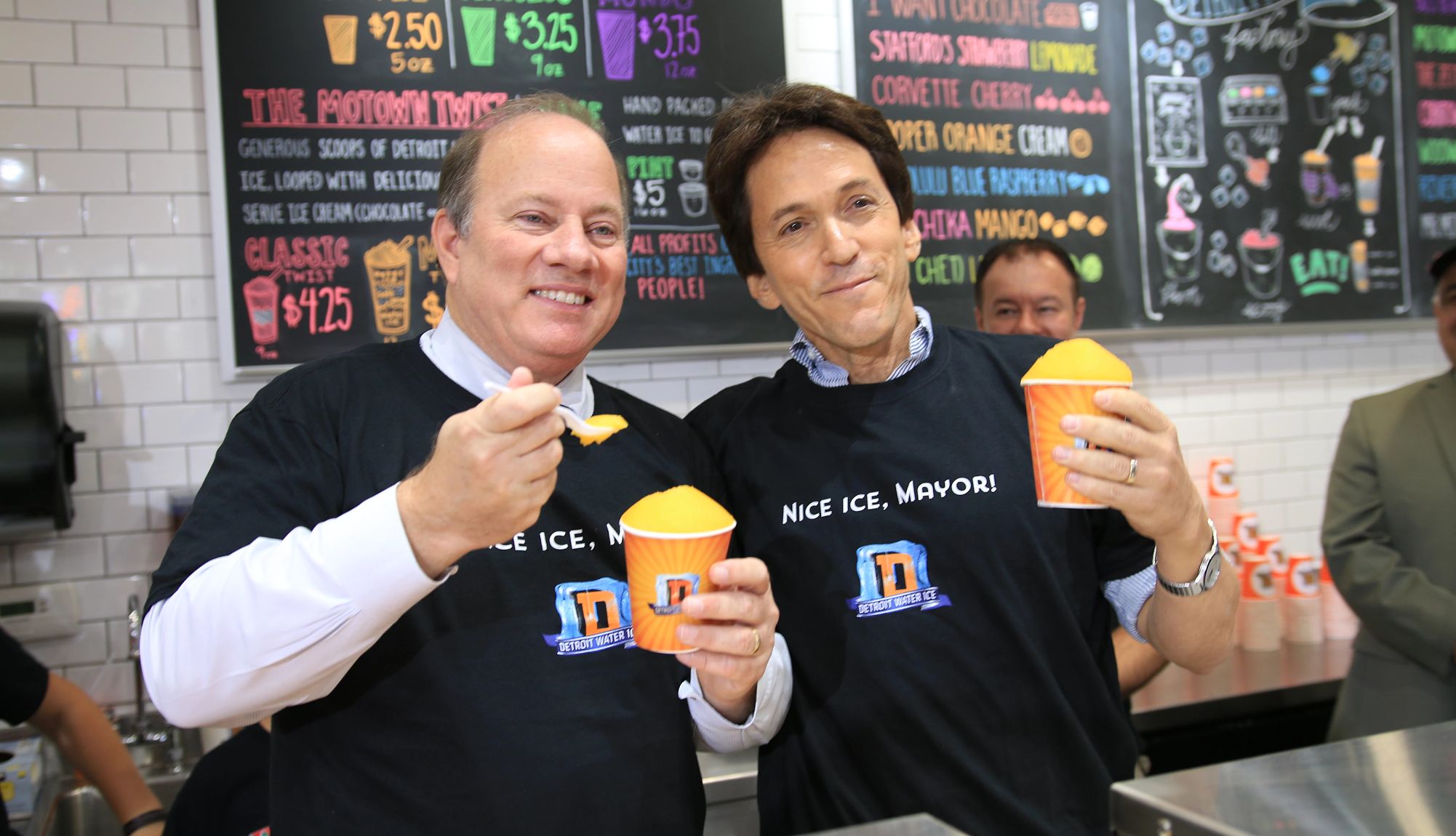 Detroit Water Ice Factory Detroit Mayor Mike Duggan and Mitch Albom holding cups of water ice at the Detroit Water Ice Factory