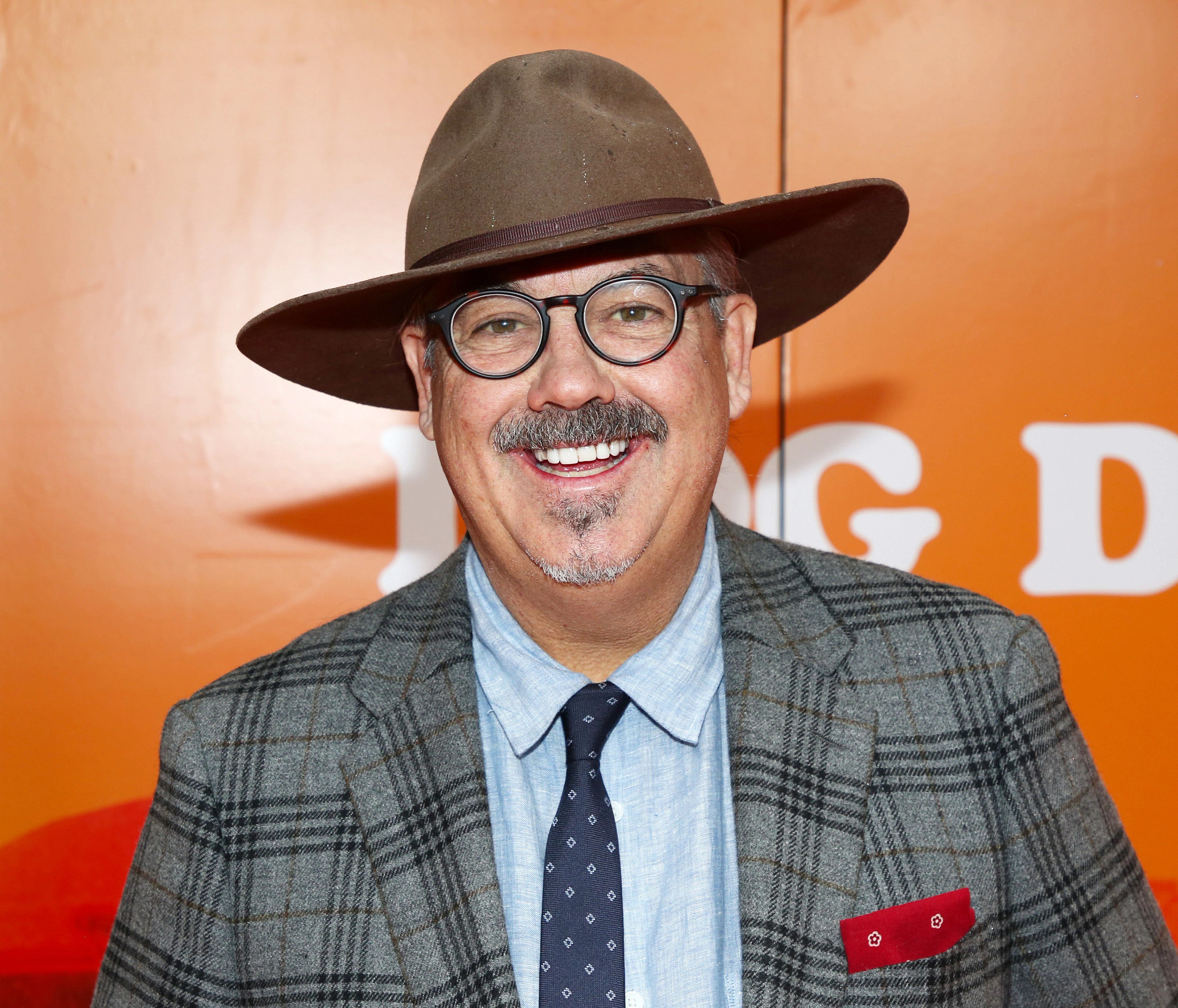 duncan sheik smiling in a hat and glasses