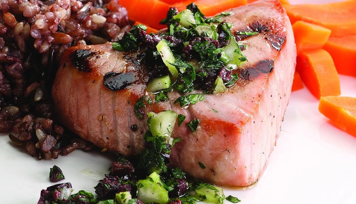 Grilled tuna with olive relish A close-up view of grilled tuna with olive relish