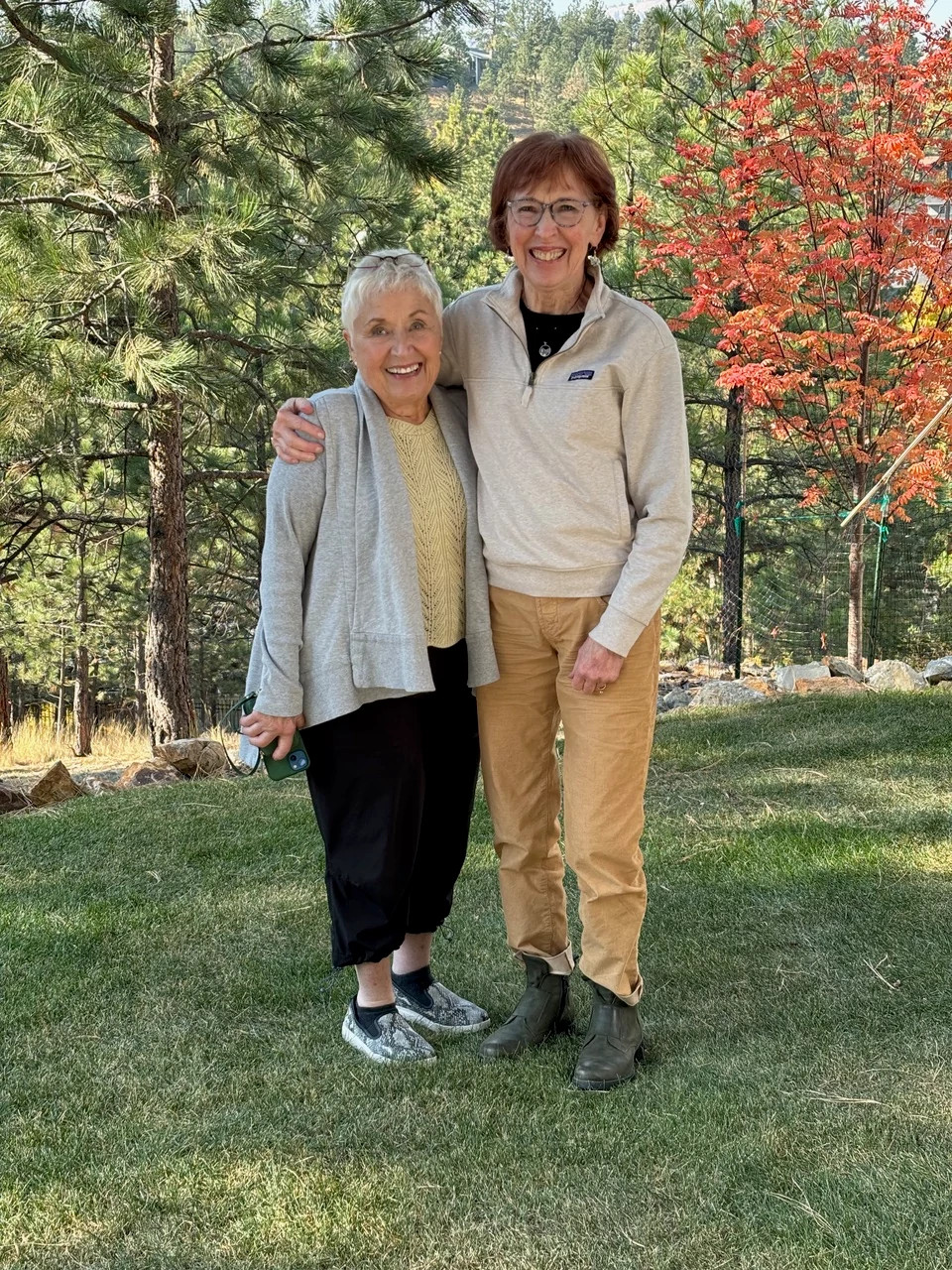 diane carlson evans and her wartime buddy edie standing together outdoors in autumn