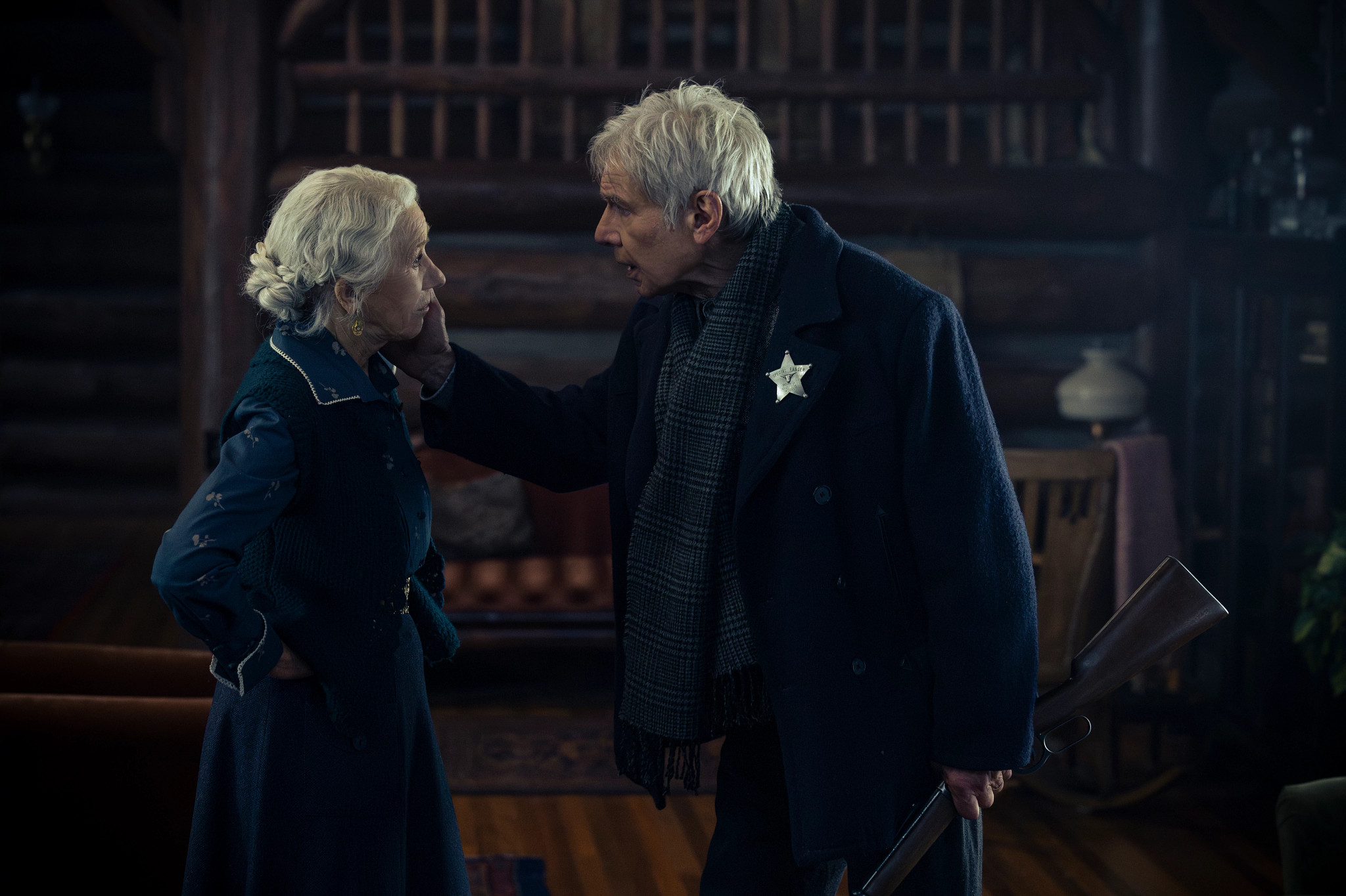 In an intense scene from the Yellowstone prequel, Jacob Dutton is gripping a long gun, and Cara Dutton stands defiant