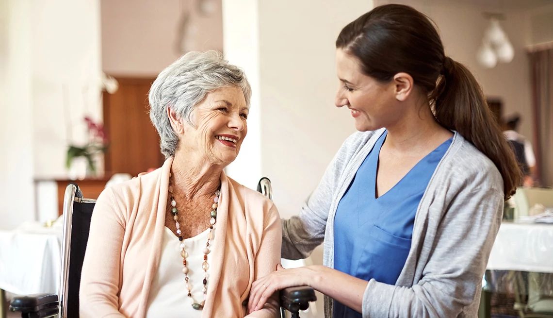 Caregiving programs can provide support for those with dementia A female nurse helping a senior woman in a caregiving capacity