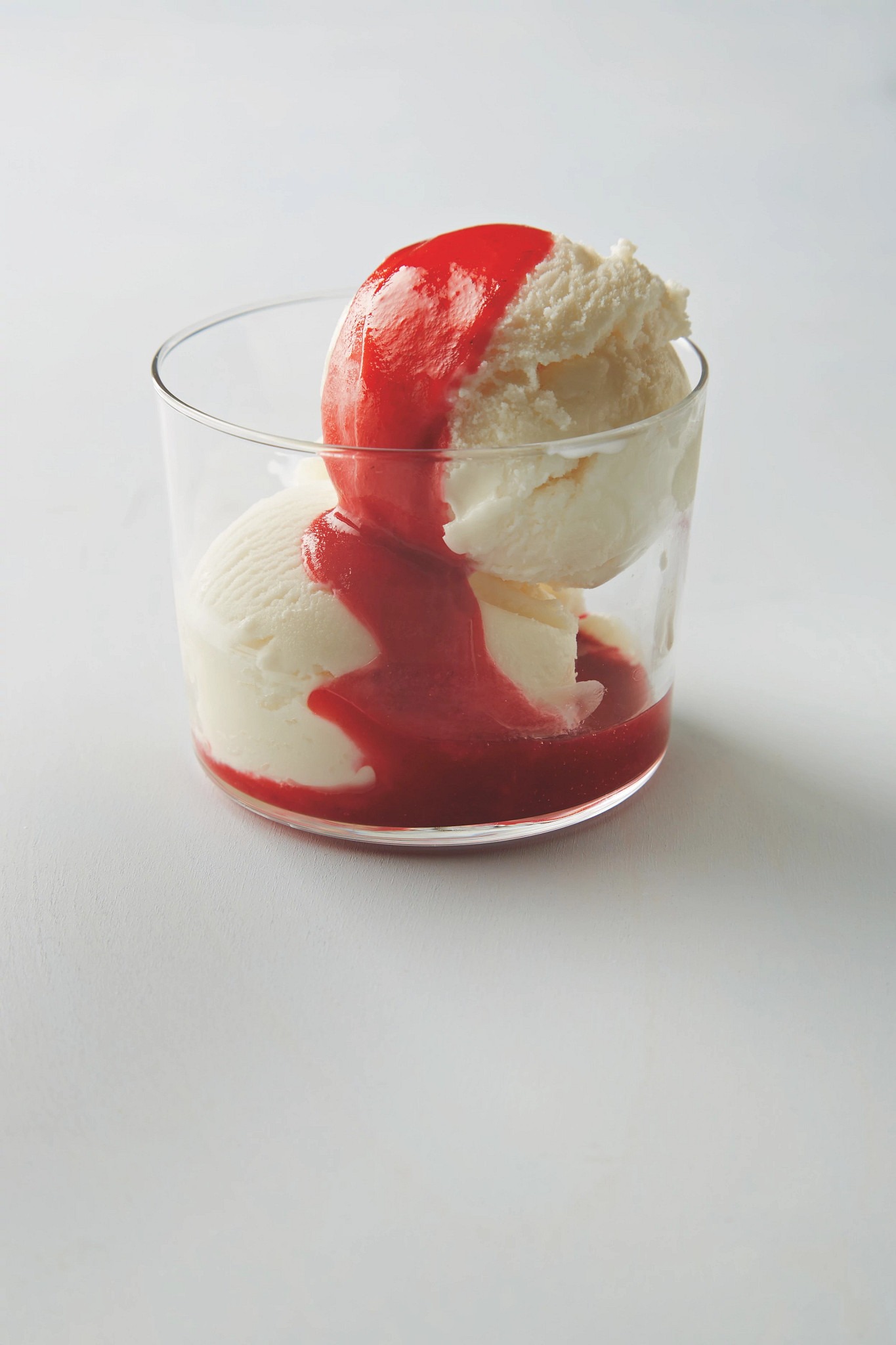 Frozen yogurt with raw strawberry sauce is pictured in a bowl