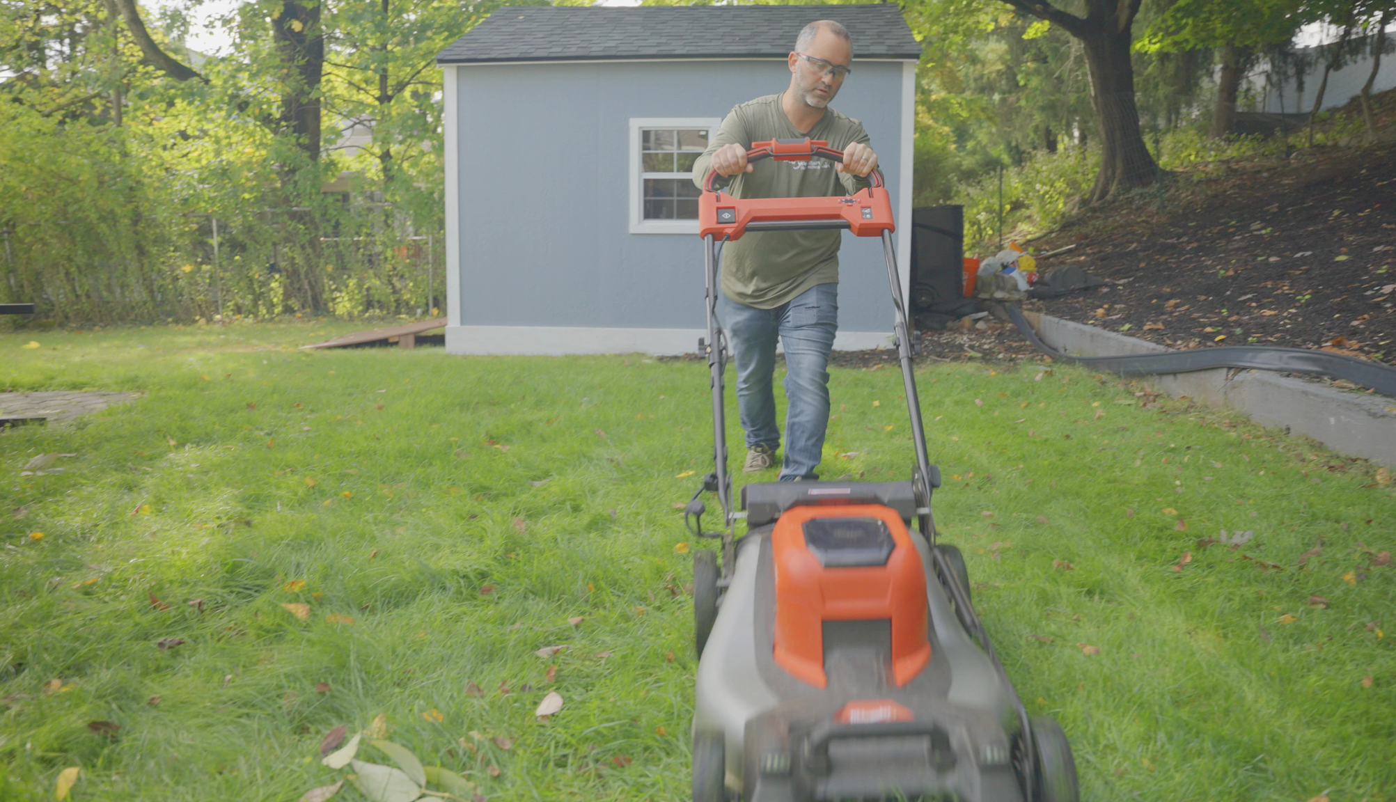 Man provides free lawn care for people in need a man mowing a yard