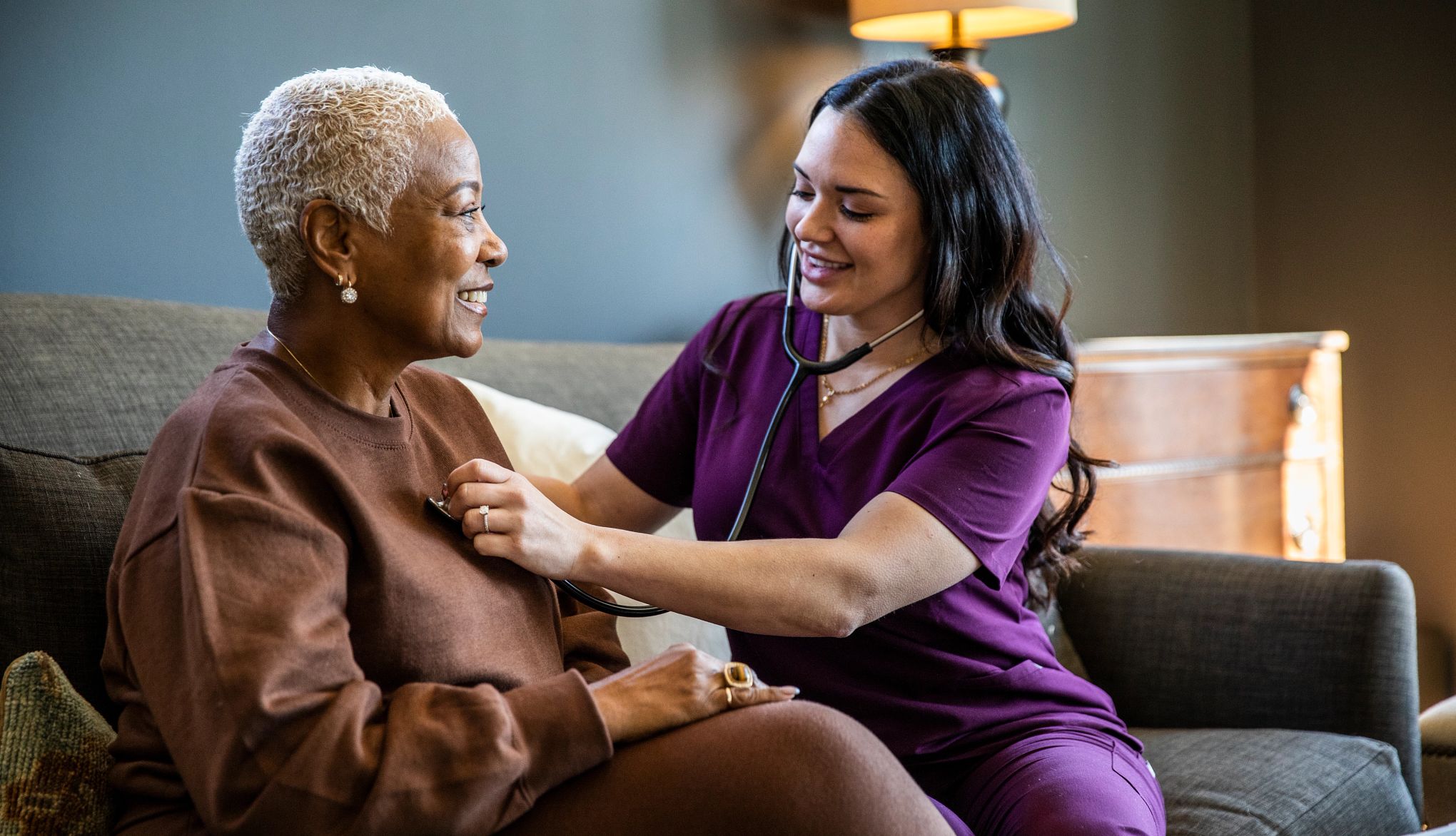 How to Pay for a Home Care Worker nurse checking senior woman's vital signs in her home