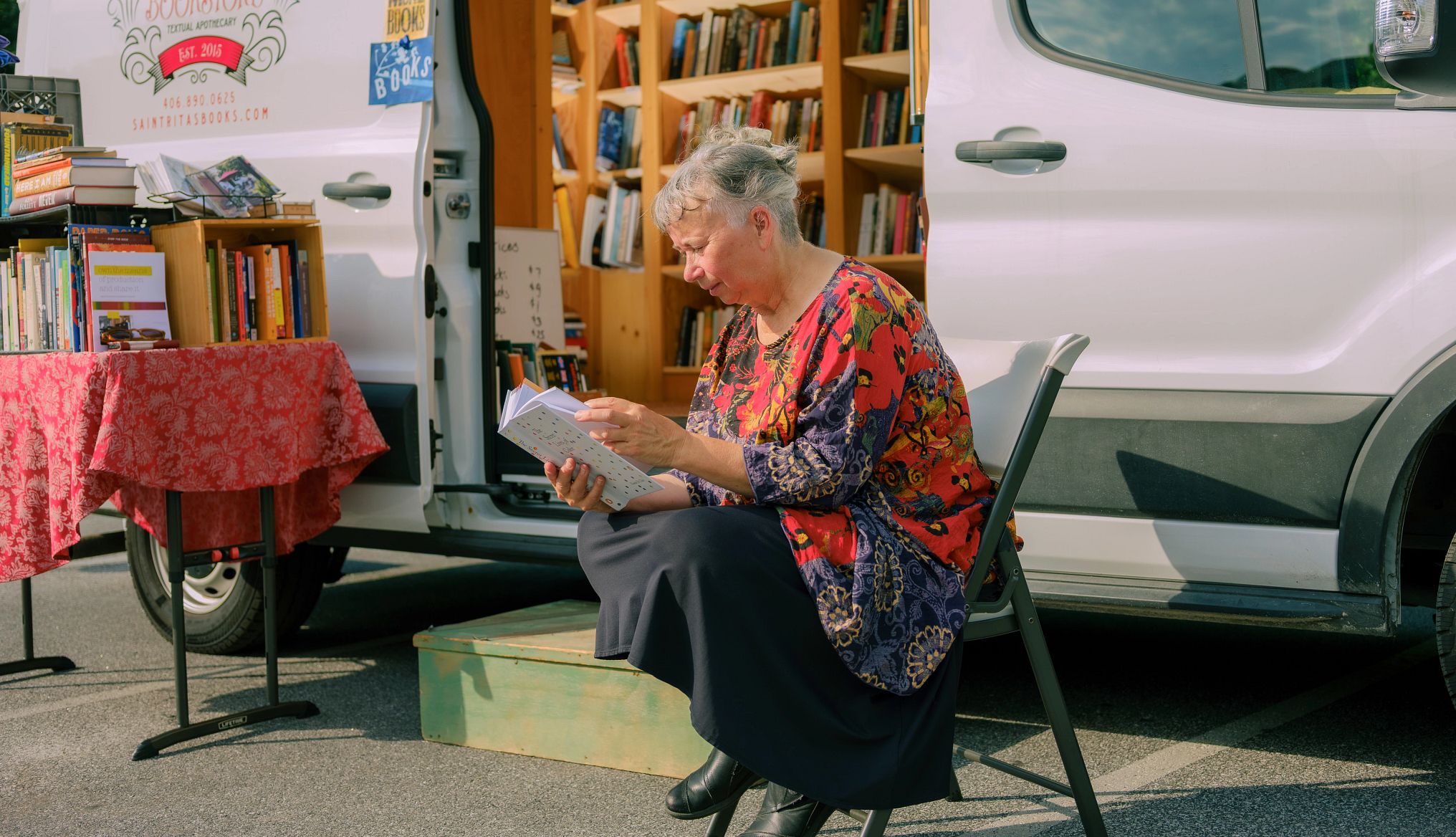 The Bookstore That Comes to You A photo shows Rita Collins outside the van that houses her traveling bookstore