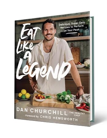 Cookbook 'Eat Like a Legend: Delicious, Super Easy Recipes to Perform at Your Peak' by Dan Churchill Cookbook that says Eat Like a Legend Delicious, Super Easy Recipes to Perform at Your Peak, Dan Churchill, Foreword by Chris Hemsworth; Dan Churchill on cover with cutting board and food in front of him