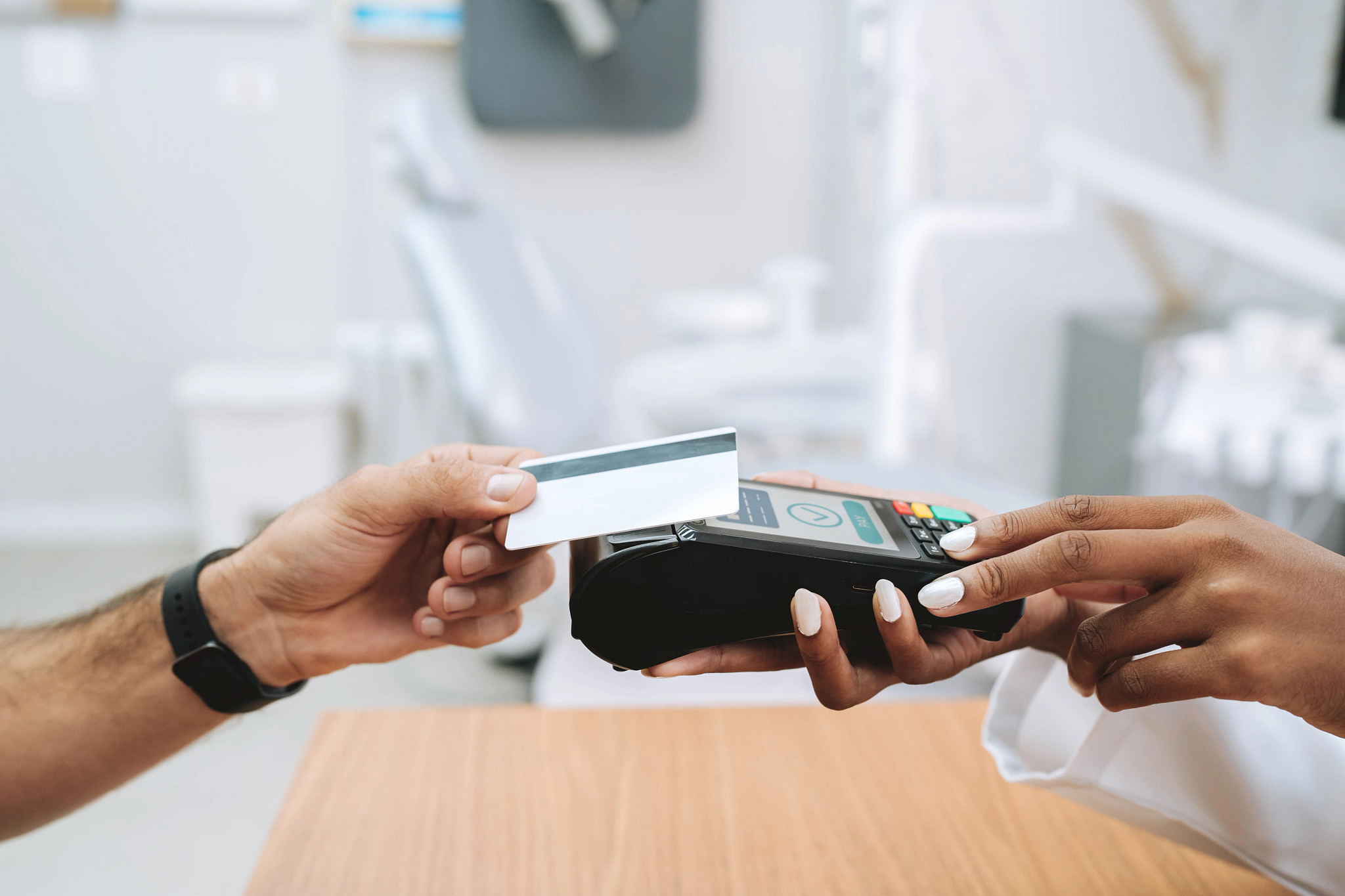 someone tapping a card to pay