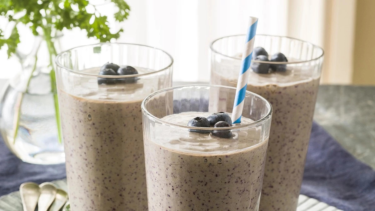 A close-up view of coconut-blueberry green smoothies