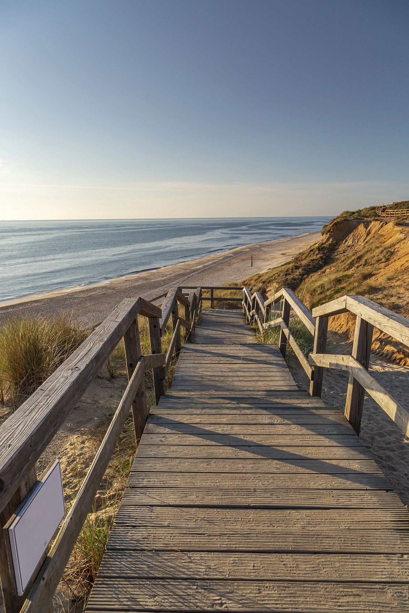 wooden stairs leading down to a beach