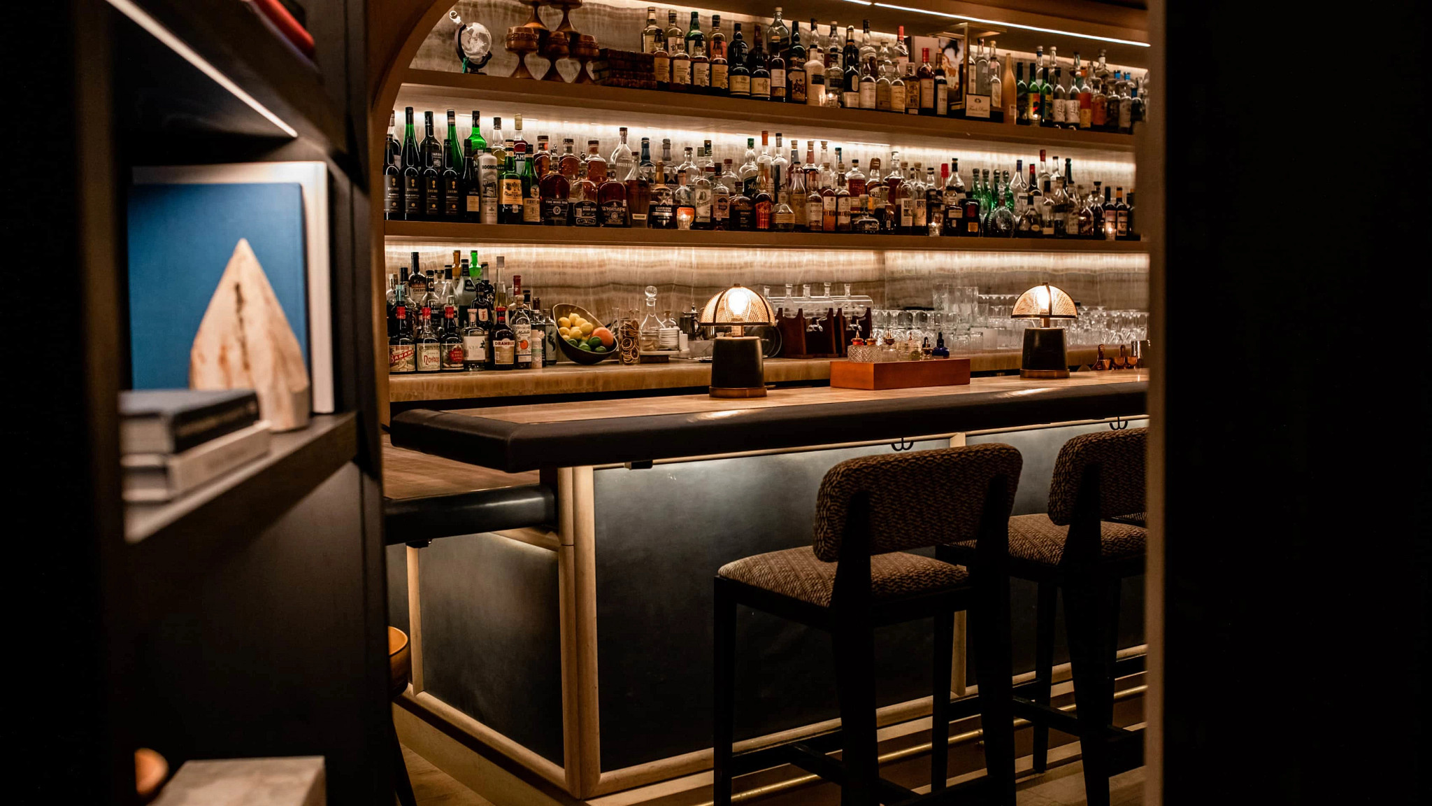 a hidden bar behind a bookshelf door