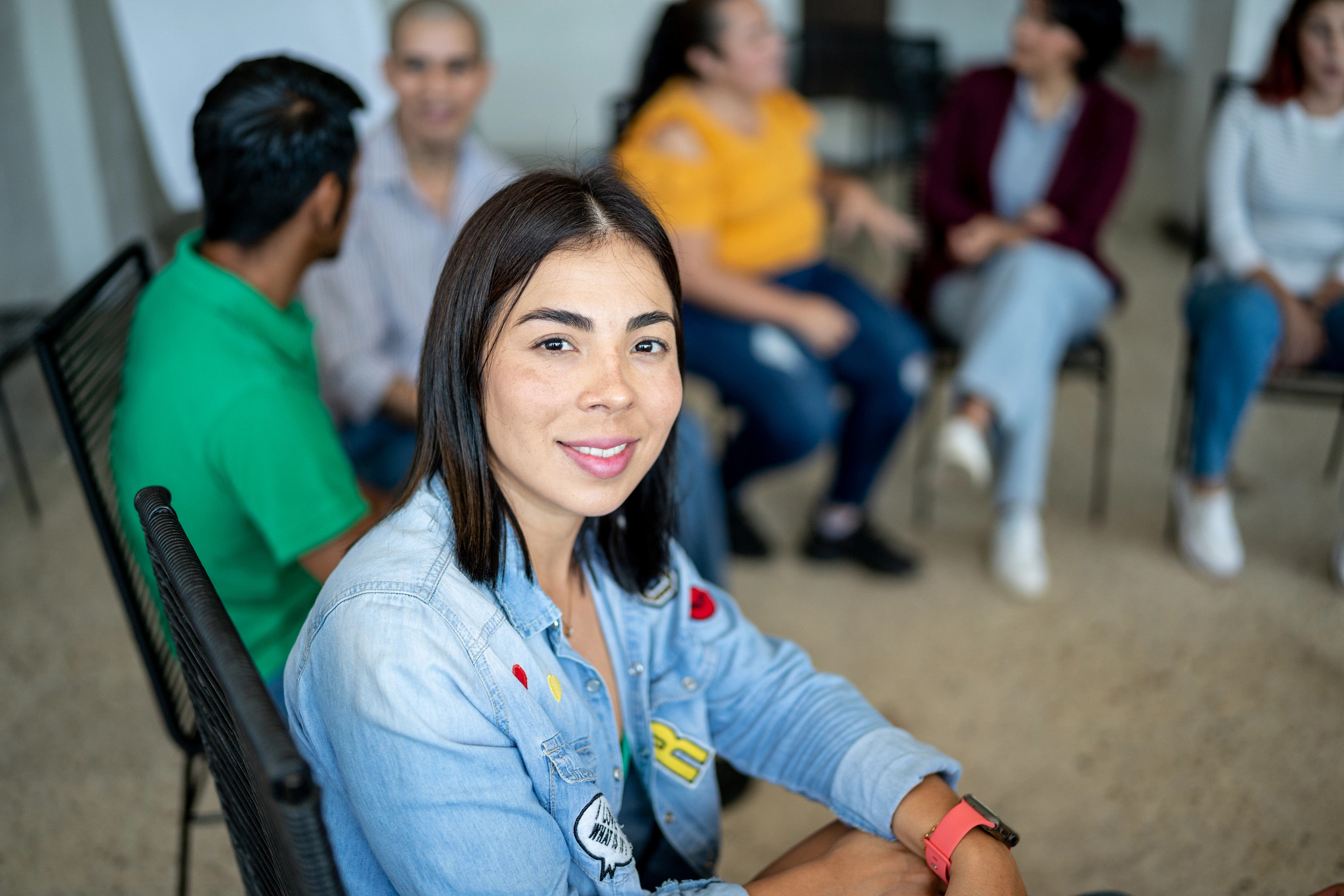 Portrait of mid adult woman during a group therapy at mental health center