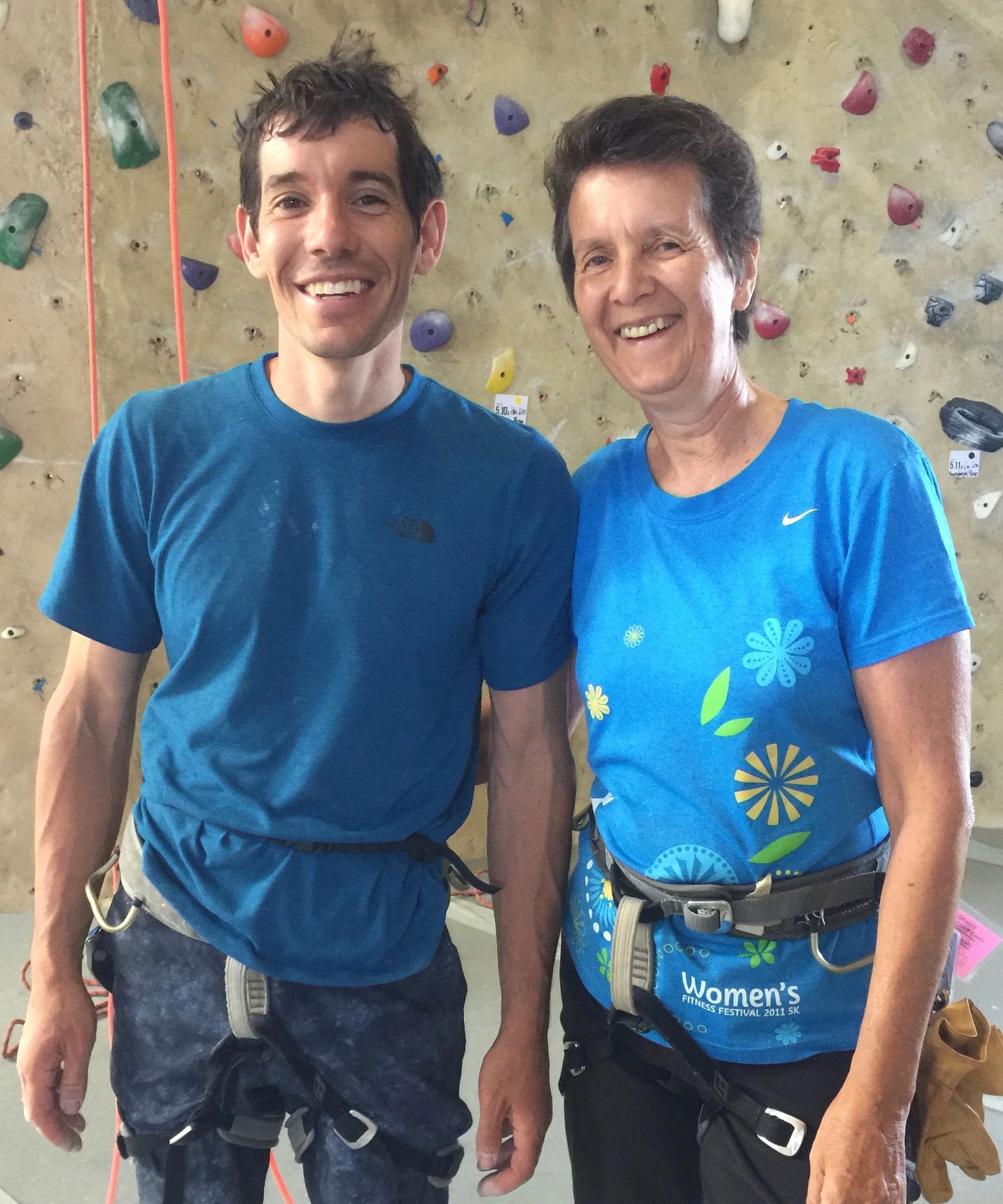 Alex Honnold and Dierdre Wolownick at rock climbing gym Alex Honnold and Dierdre Wolownick standing in front of rock climbing wall