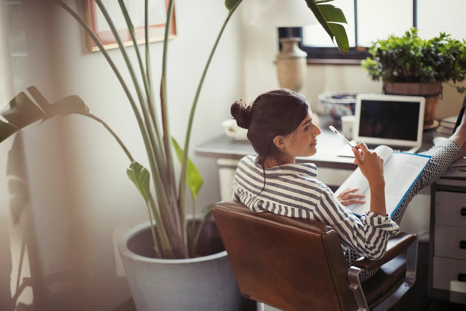 woman working from home at her desk on her computer