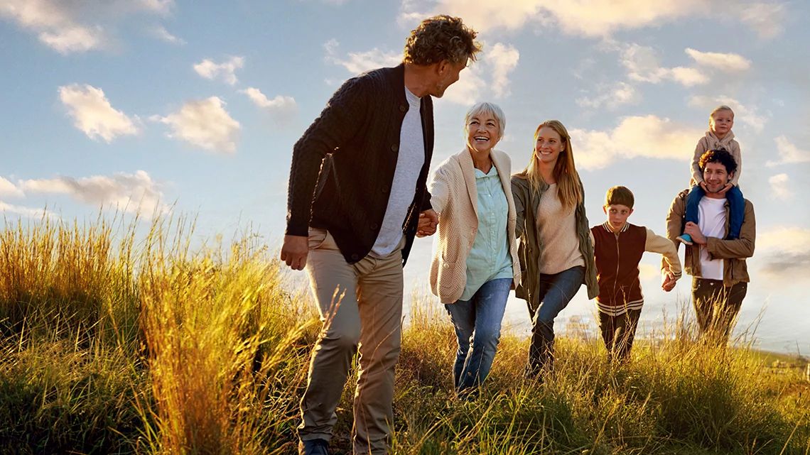 Family smiling and holding hands.