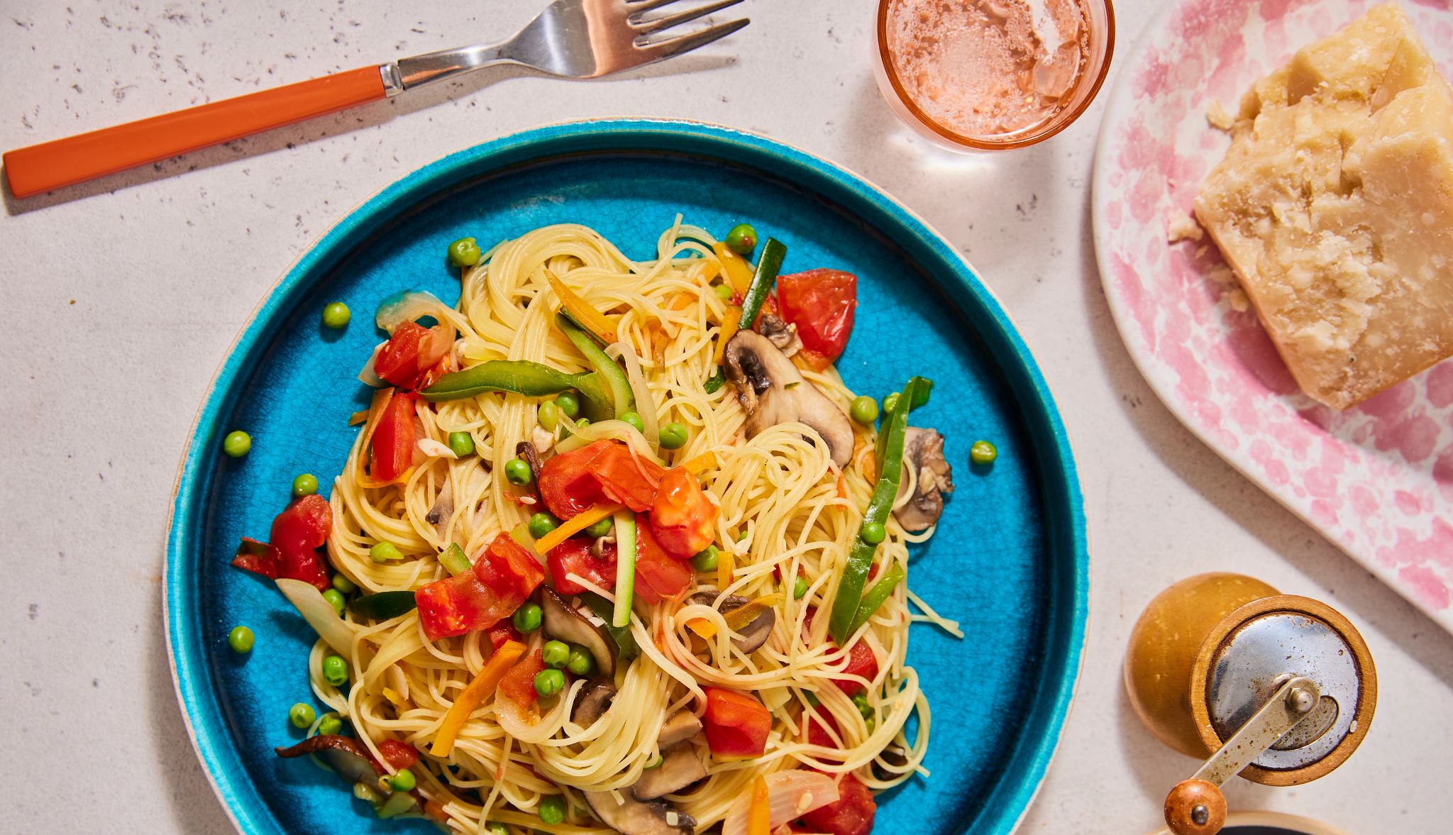 The Whole Garden Pasta Primavera Recipe Spaghetti with peas, mushrooms, tomatoes, carrots and peppers in it on plate