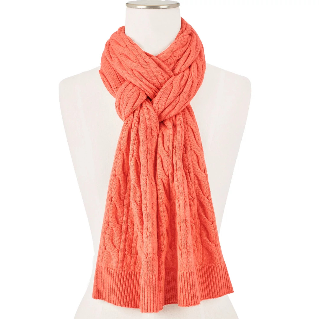 Coral cable-knit scarf wrapped around a white dress-form mannequin demonstrating styling options