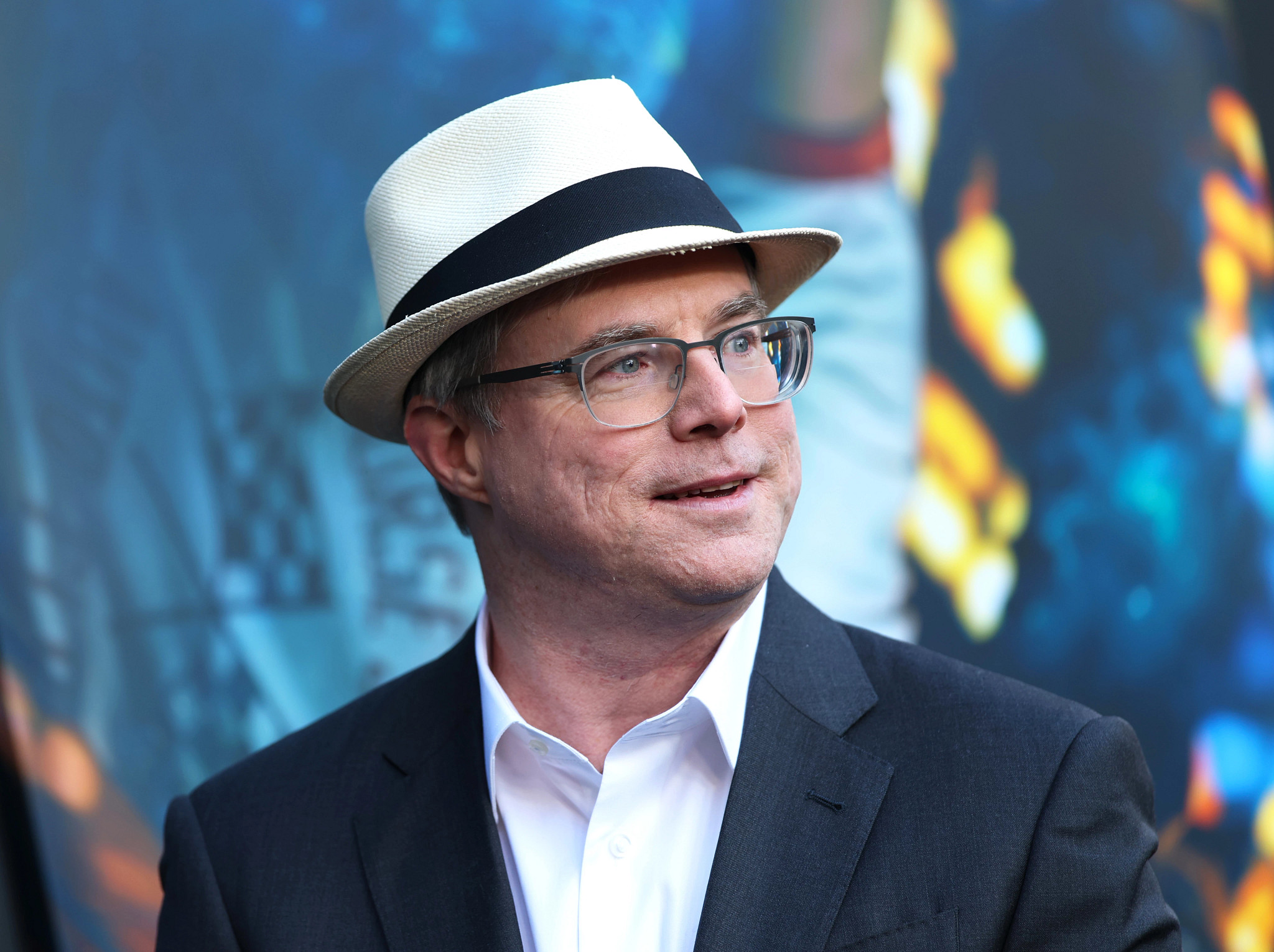 andy weir wearing a white fedora hat and glasses