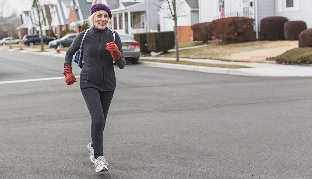 Walking for exercise supports good health in myriad ways A woman power walking through a neighborhood