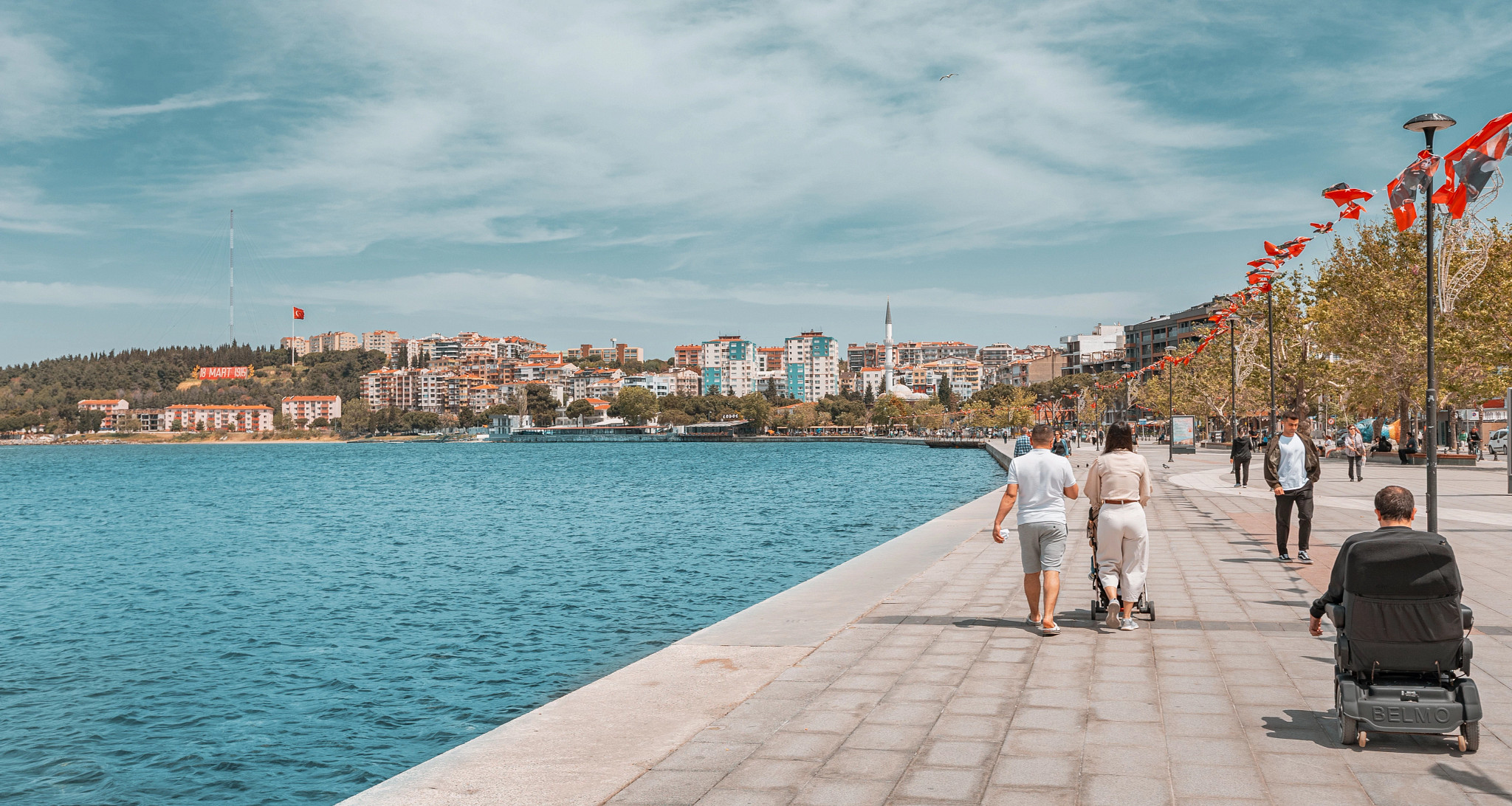 people walking on a promenade in Çanakkale, Turkey