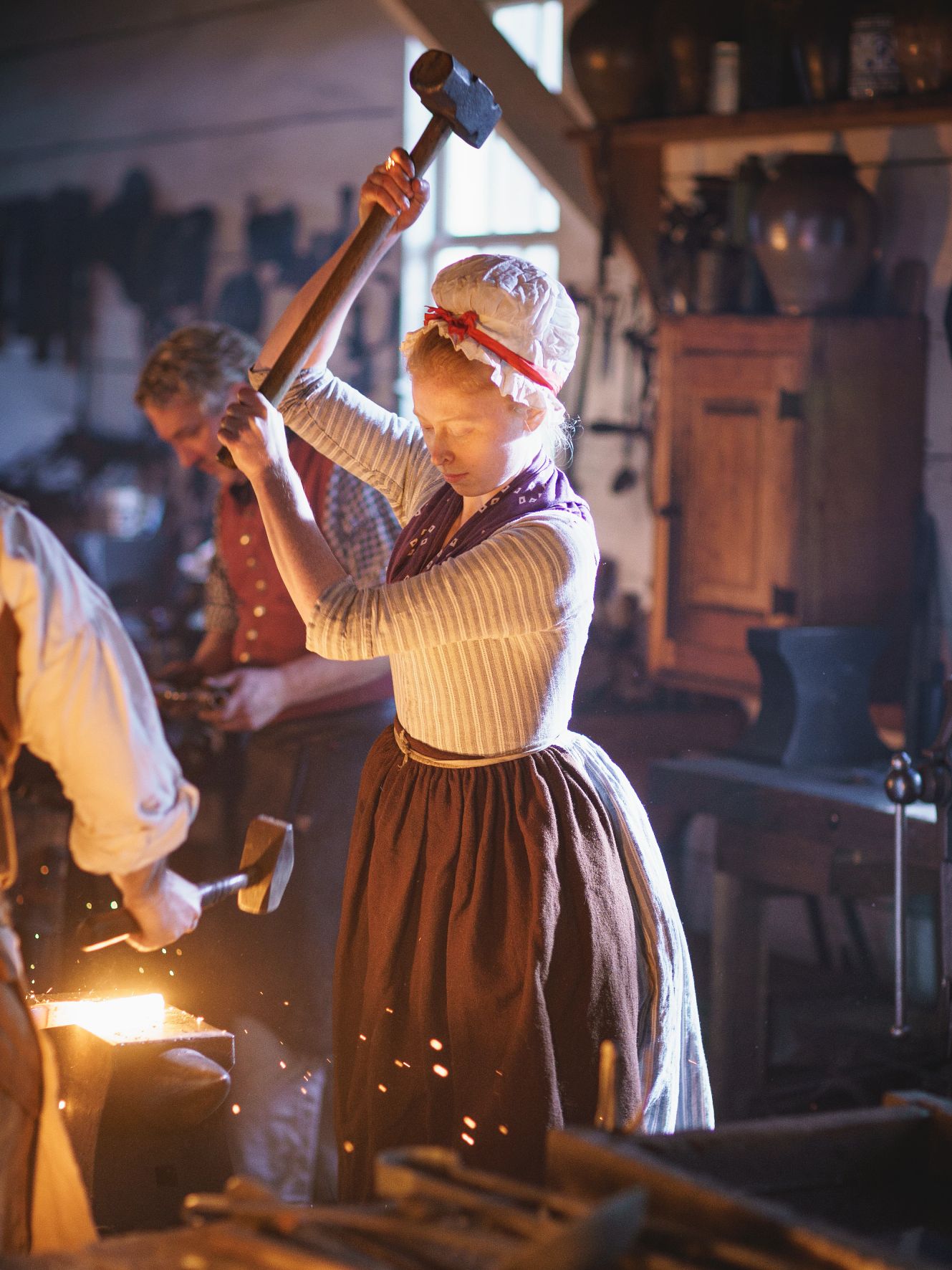 Living History Museums A blacksmith works at a forge