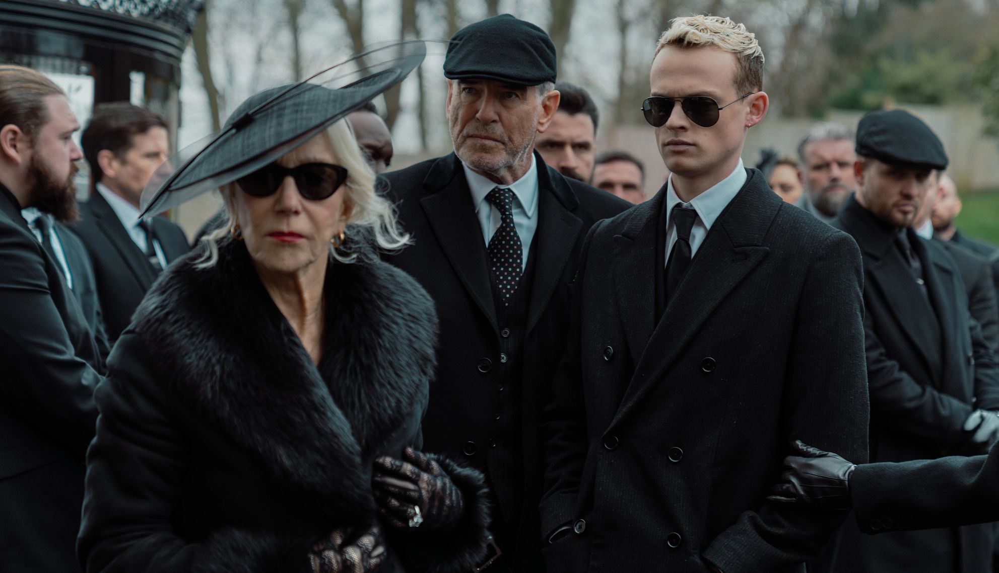 solemn gathering mirren Helen Mirren, impeccably dressed, amidst a sea of black.