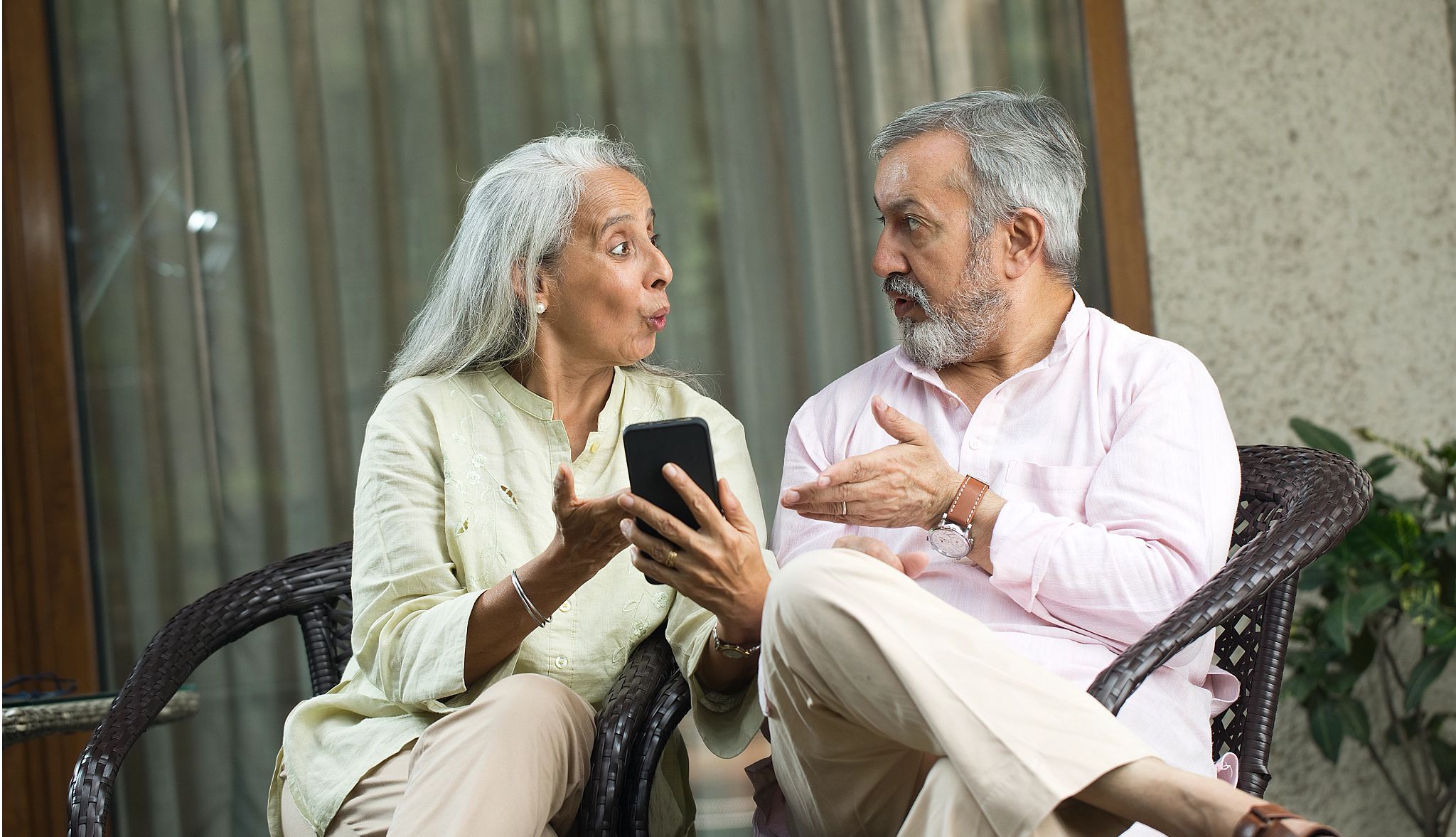 Older couple looking at each other with concern Older couple looking at each other with concern