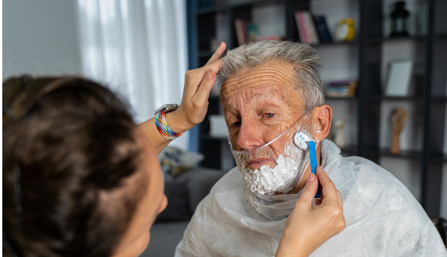 How Caregivers Can Help With Personal Hygiene in home volunteer helps an older man by shaving his face