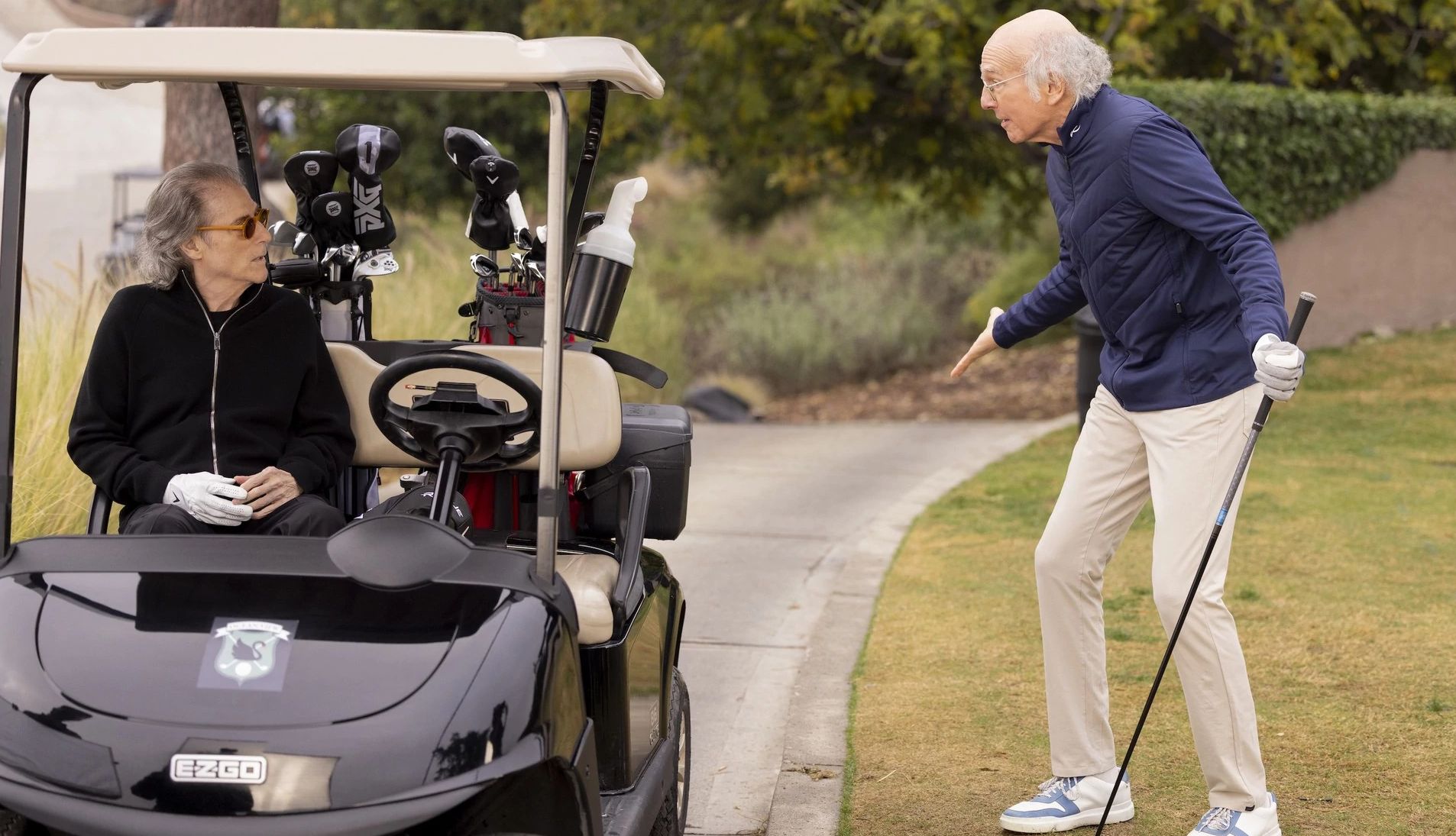Richard Lewis sitting in a golf cart and Larry David holding a gold club in "Curb Your Enthusiasm." Richard Lewis sitting in a golf cart and Larry David holding a gold club in "Curb Your Enthusiasm."