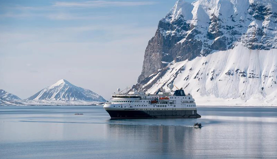 Cruise ship in the Arctic with breathtaking views of snowy mountains in the background