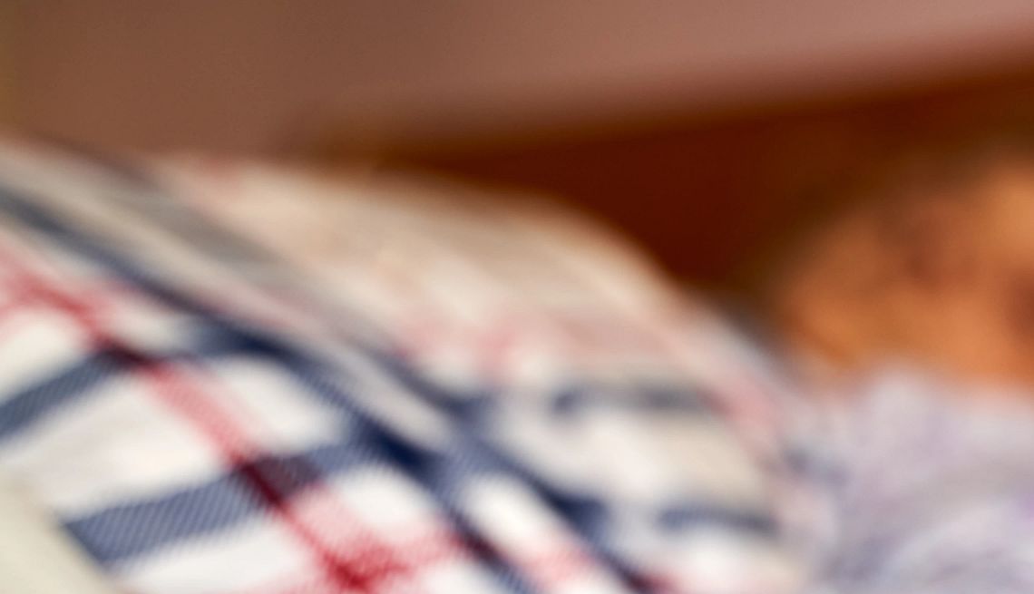 What to Know About Bedsores close-up of a person's hand as they lay in a bed