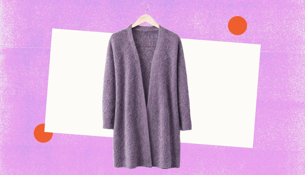 an oversized open front cardigan in soft purple on a background with lavender and orange shapes