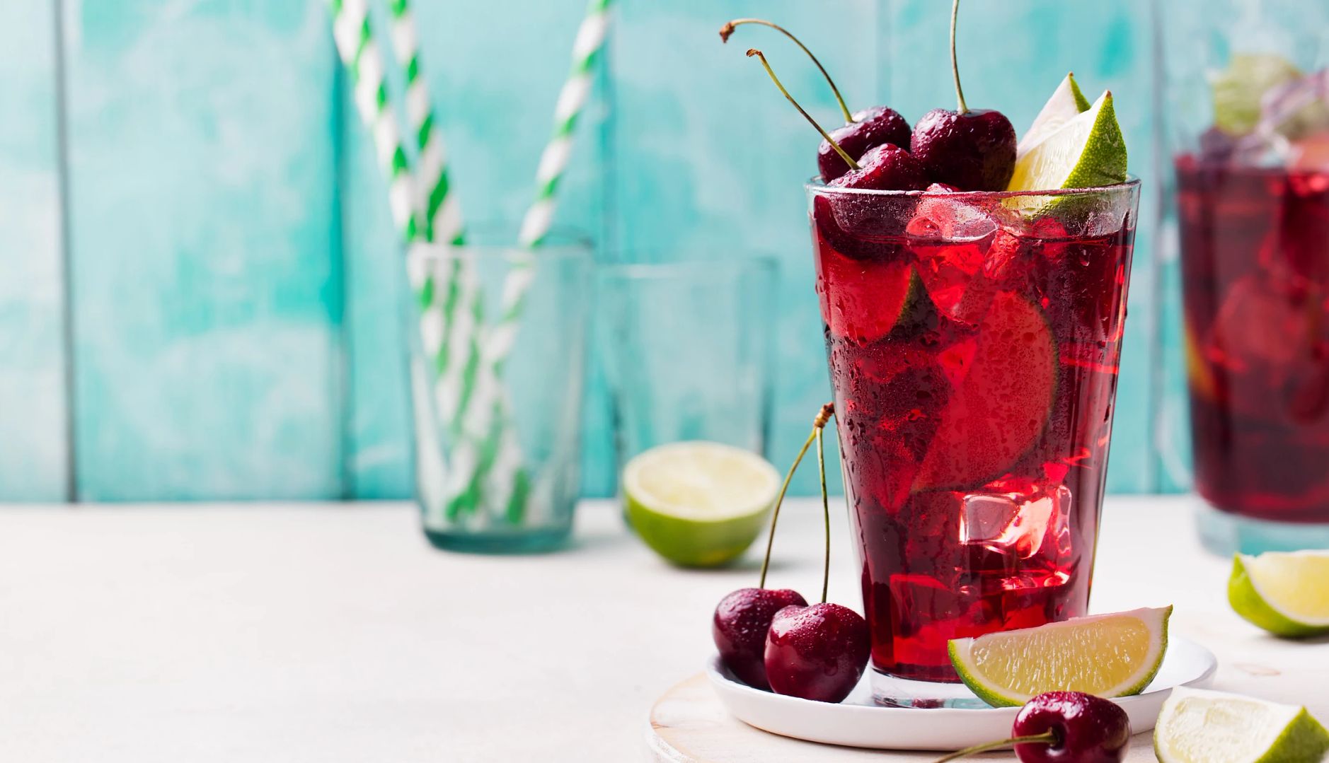 Can Drinking Tart Cherry Juice Lower Blood Pressure? a fresh glass of tart cherry juice filled with lime wedges