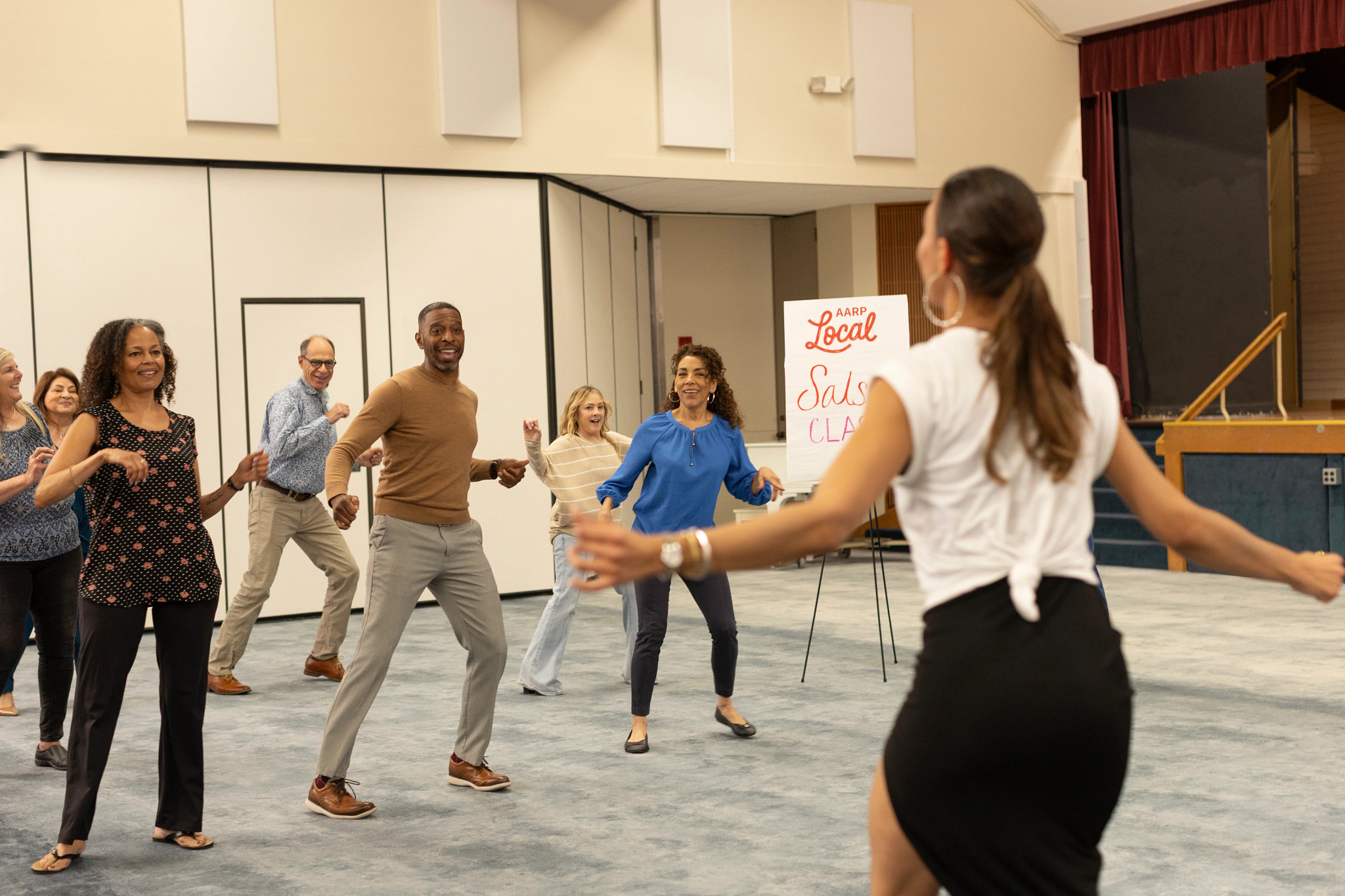 Participants learn and practice salsa dance moves during an AARP Local class Pictured in photo: Lisa Russell, Rosalinda Randall, Veronica Sunseri, Micheal Berckart James Nicholas, Sheryl Kendall, Nana Ponceleon 