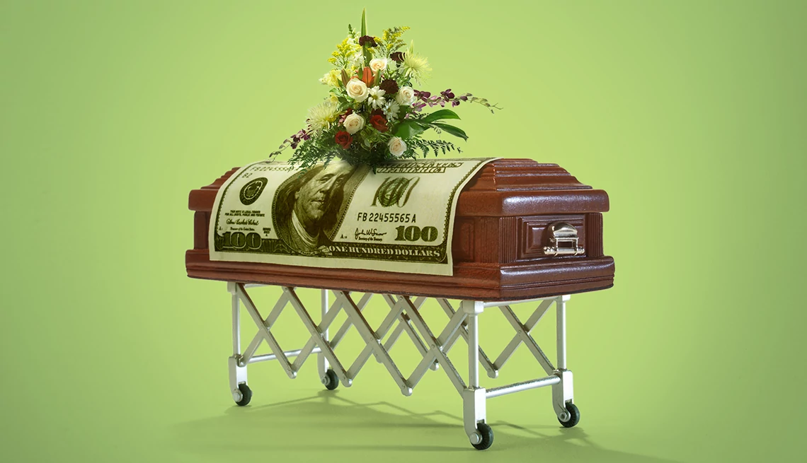 Save on Funeral Costs a casket with money on top of it