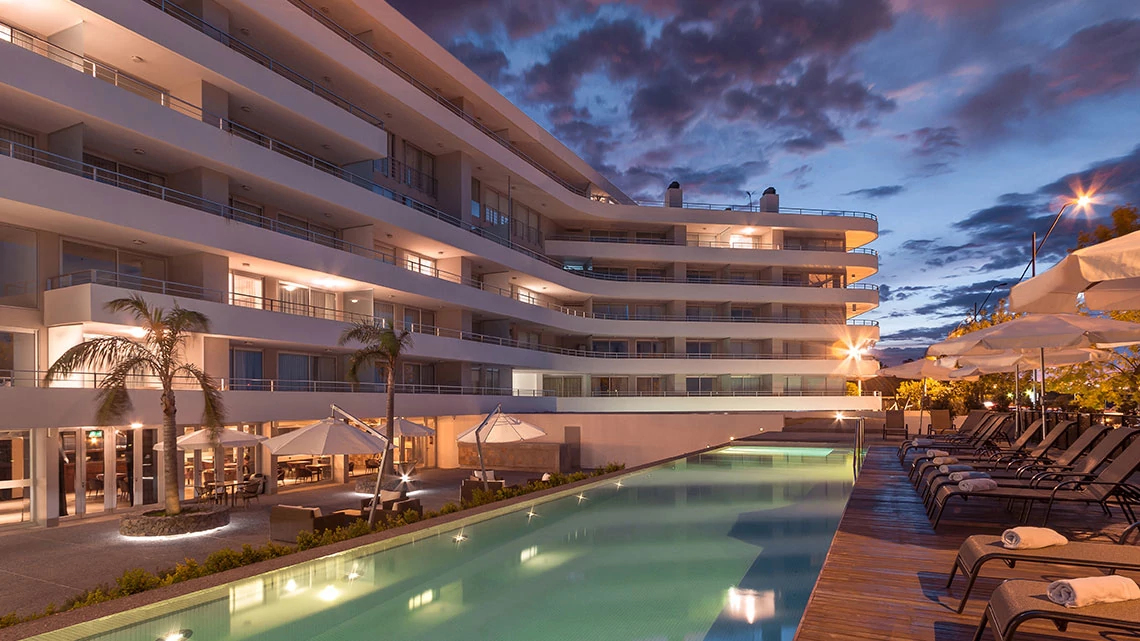 Dazzler® by Wyndham Pool view of the Dazler hotel property at night