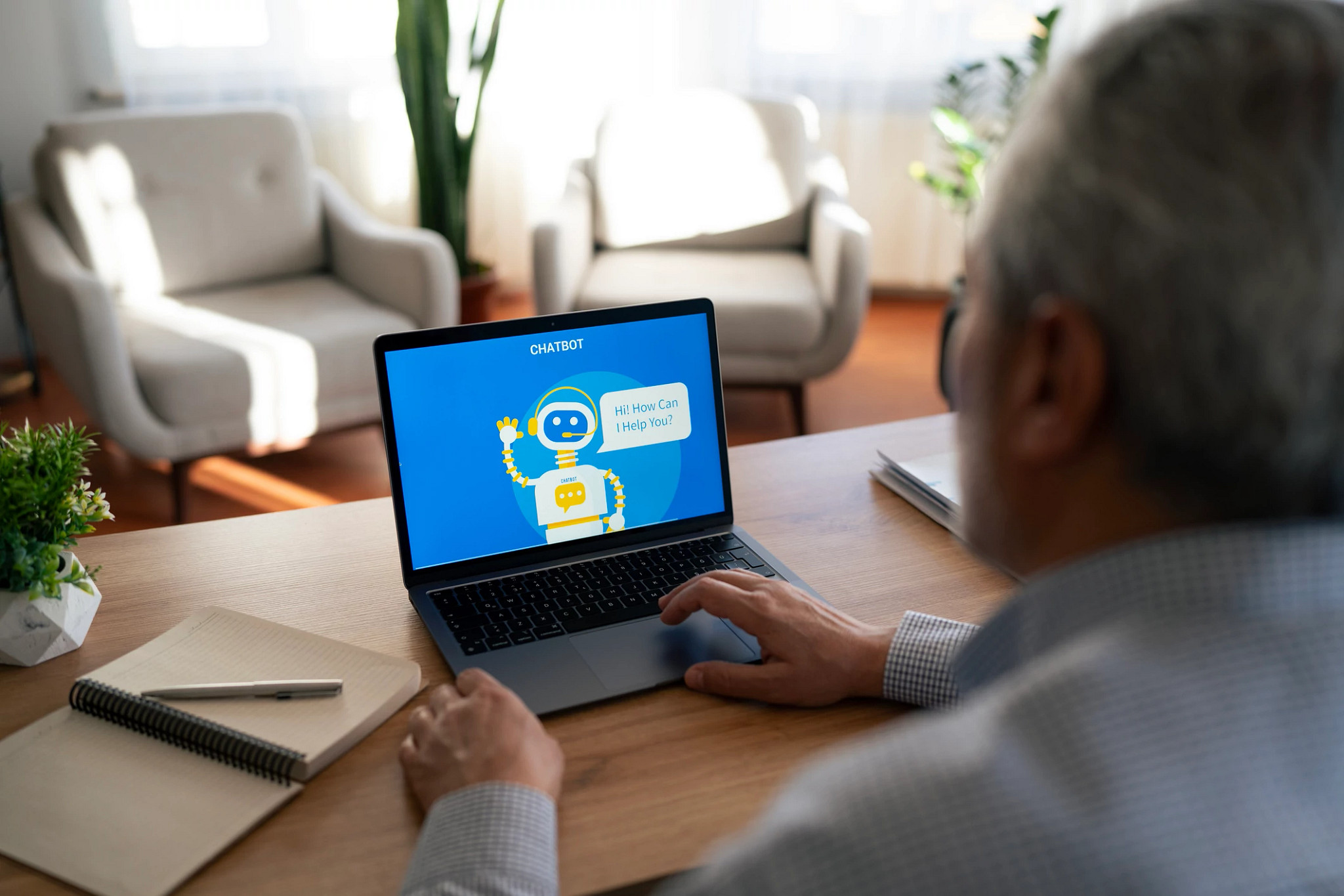 Senior man interacting with an ai chatbot on a laptop computer, seeking support