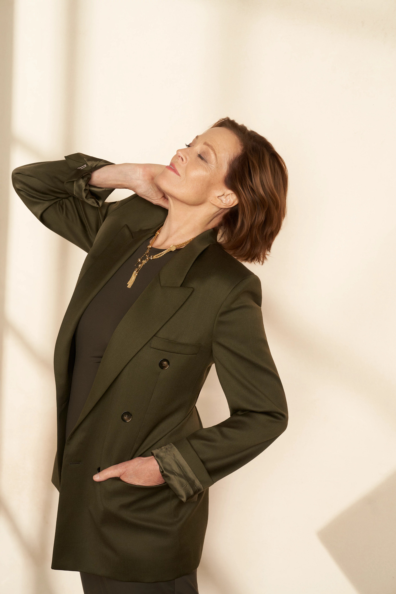 sigourney weaver posing for a portrait in a suit jacket