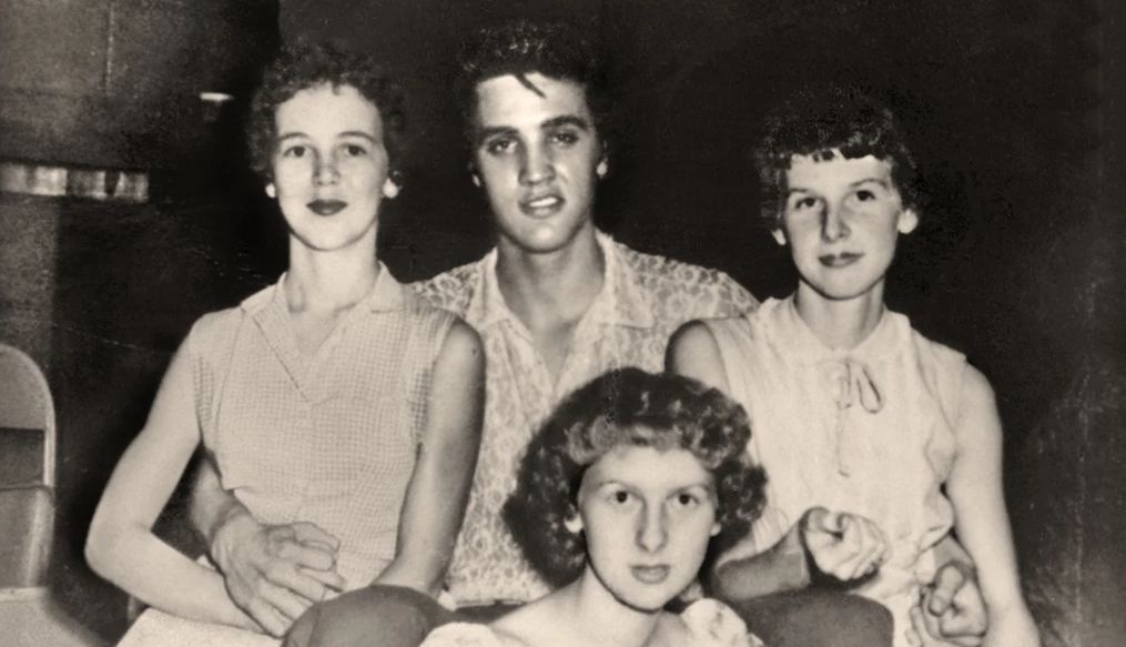 The Night My Mom Met Elvis young elvis presley posing for a photo with three teenage girls