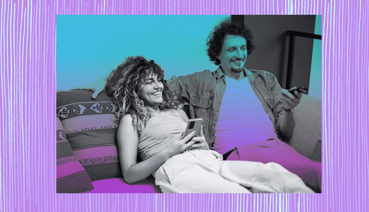 A happy married couple relaxing on a sofa at home.