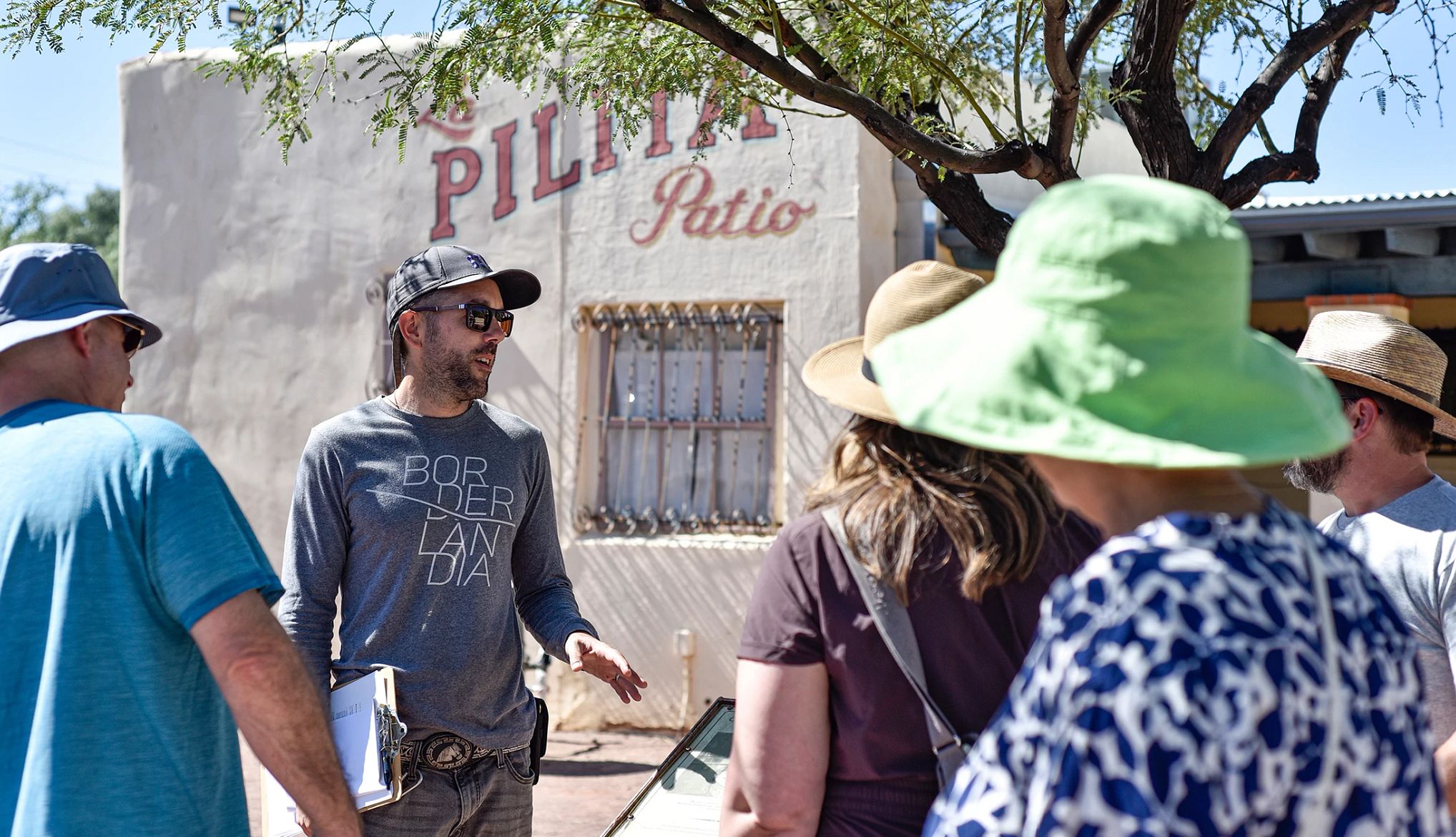 Top Walking Tours a tour guide speaks to a group standing outside of a building