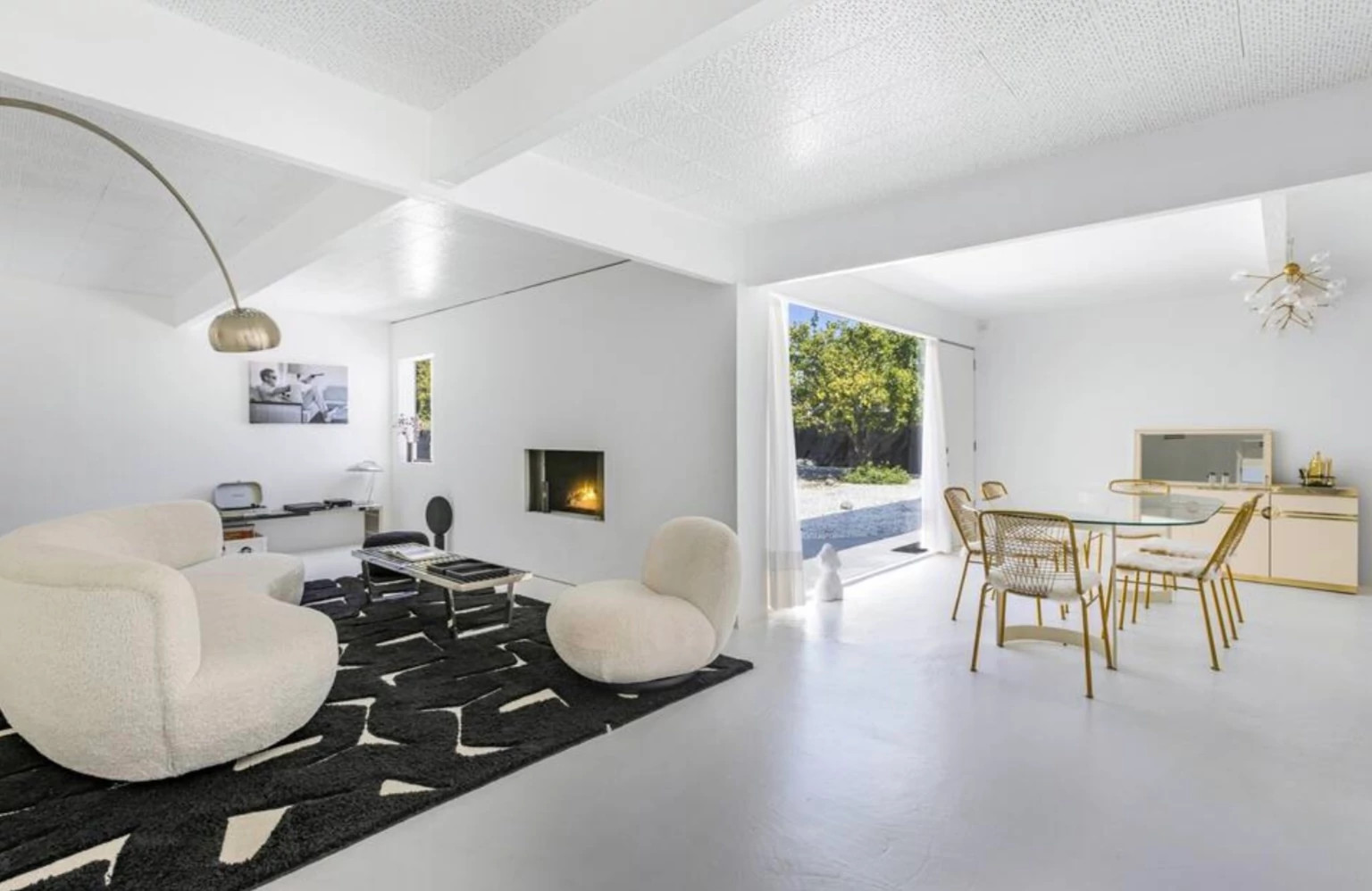 a living room with a fireplace and white and black decor