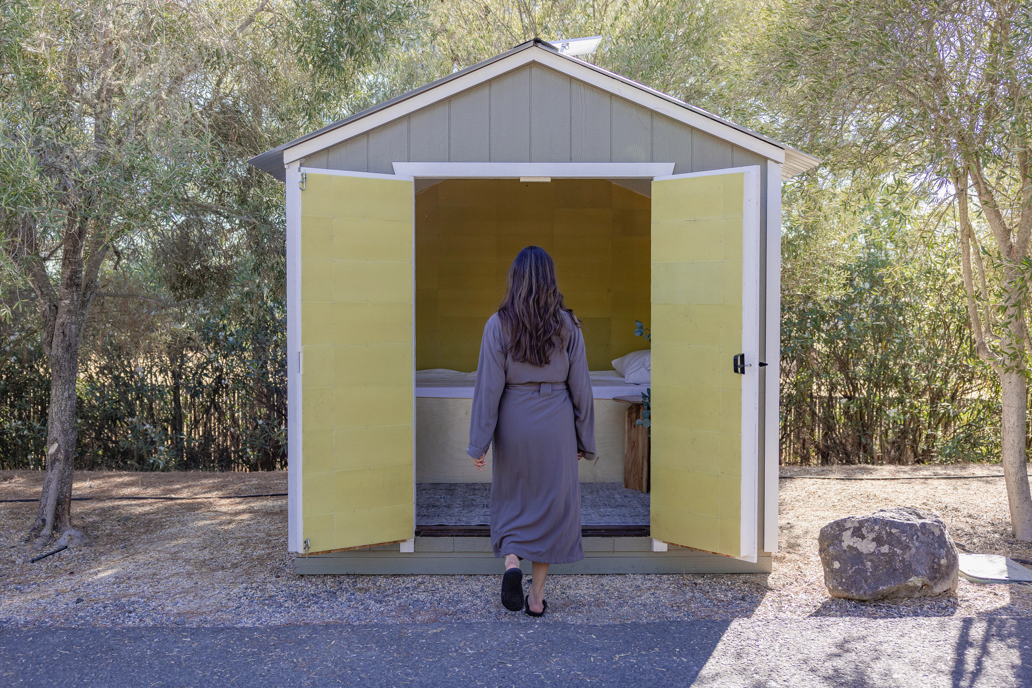 a person walking a cottage with a bed