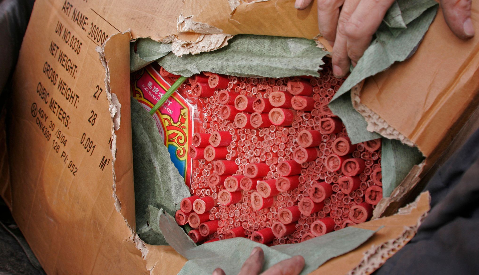 a person opening a box of fireworks